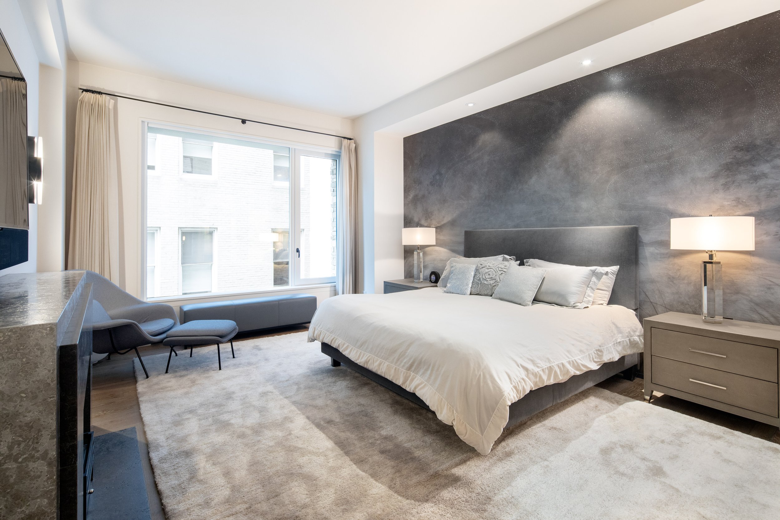  The Primary Suite boasts a fireplace and massive, dream Dressing Room with custom oak millwork and a wall of antiqued mirror closets. Pass through the Dressing Room into a five-fixture Bathroom with Carrera marble and bluestone finishes, deep soakin