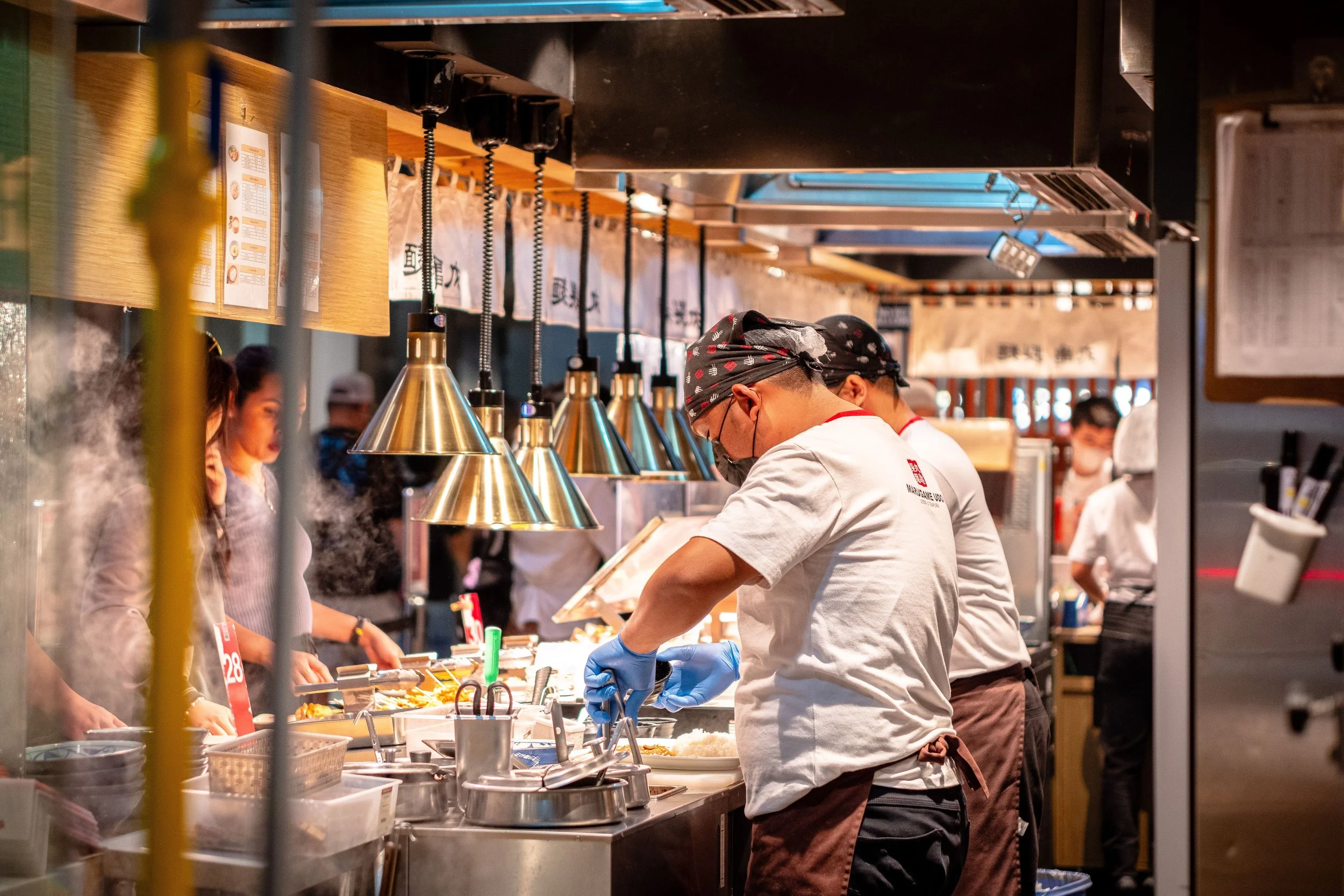 A chef working a commercial kitchen range during service