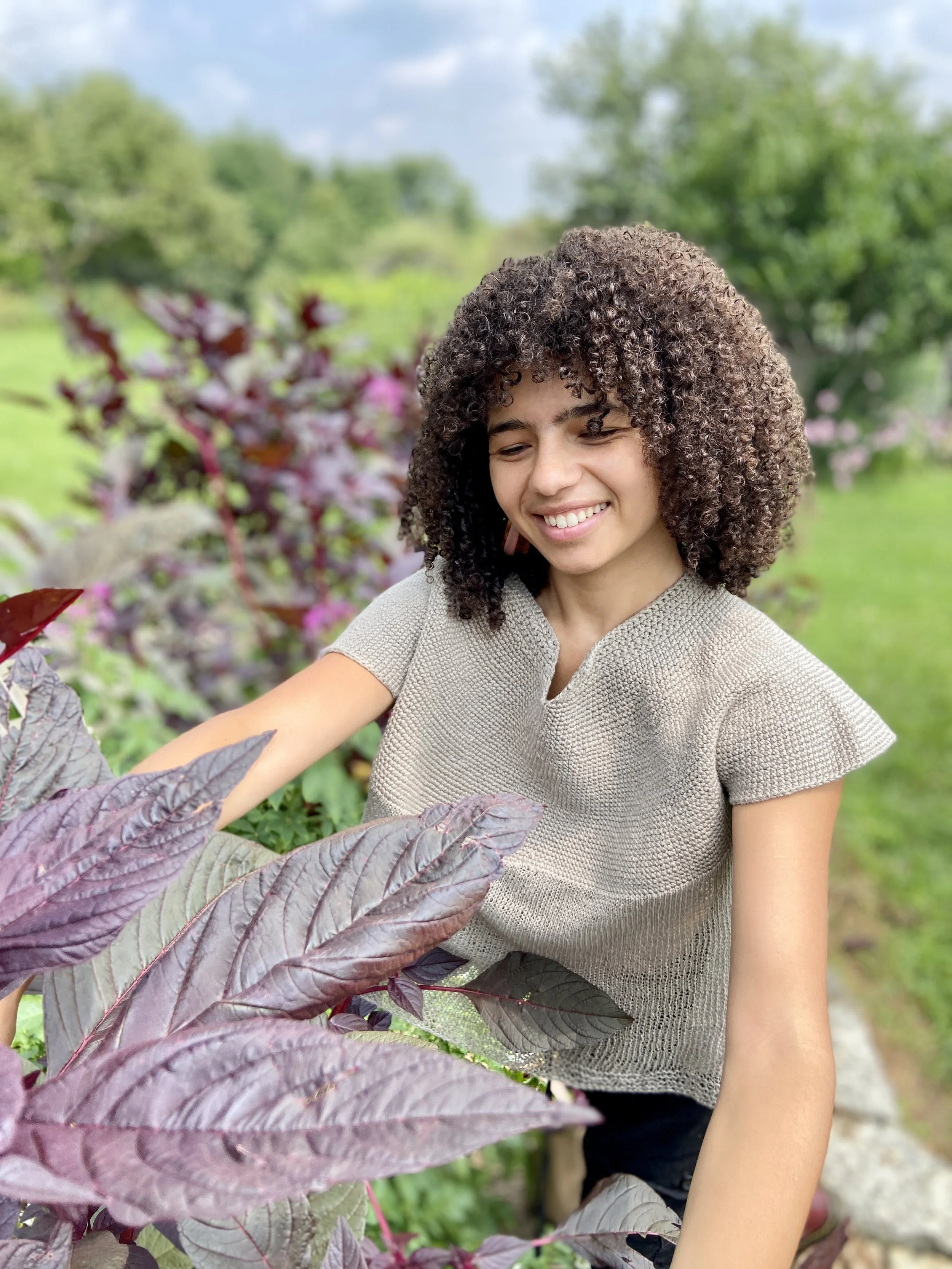 a person harvests brightly colored leaves for botanical dyeing
