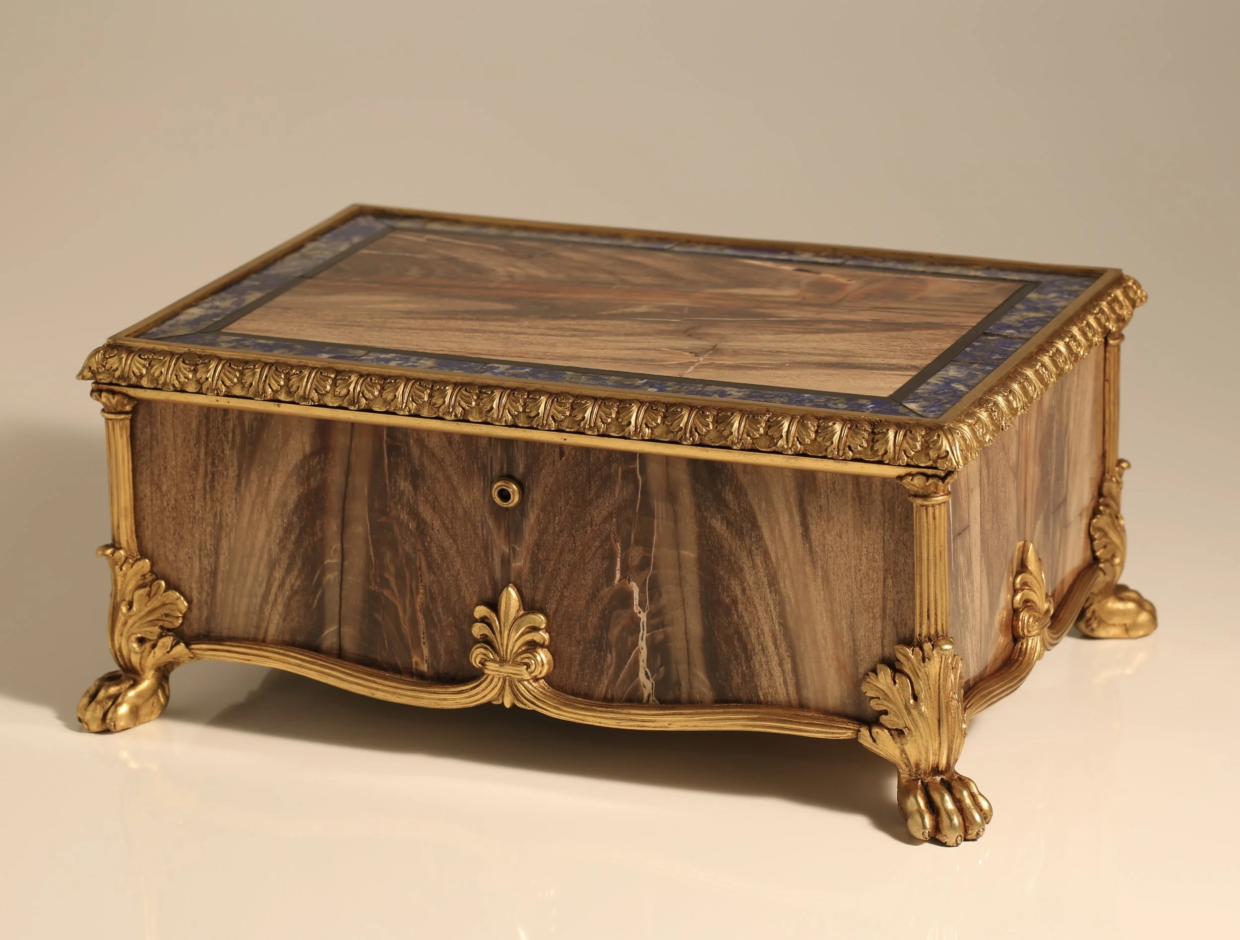 A fine quality petrified wood, ormolu and pietra dura casket.