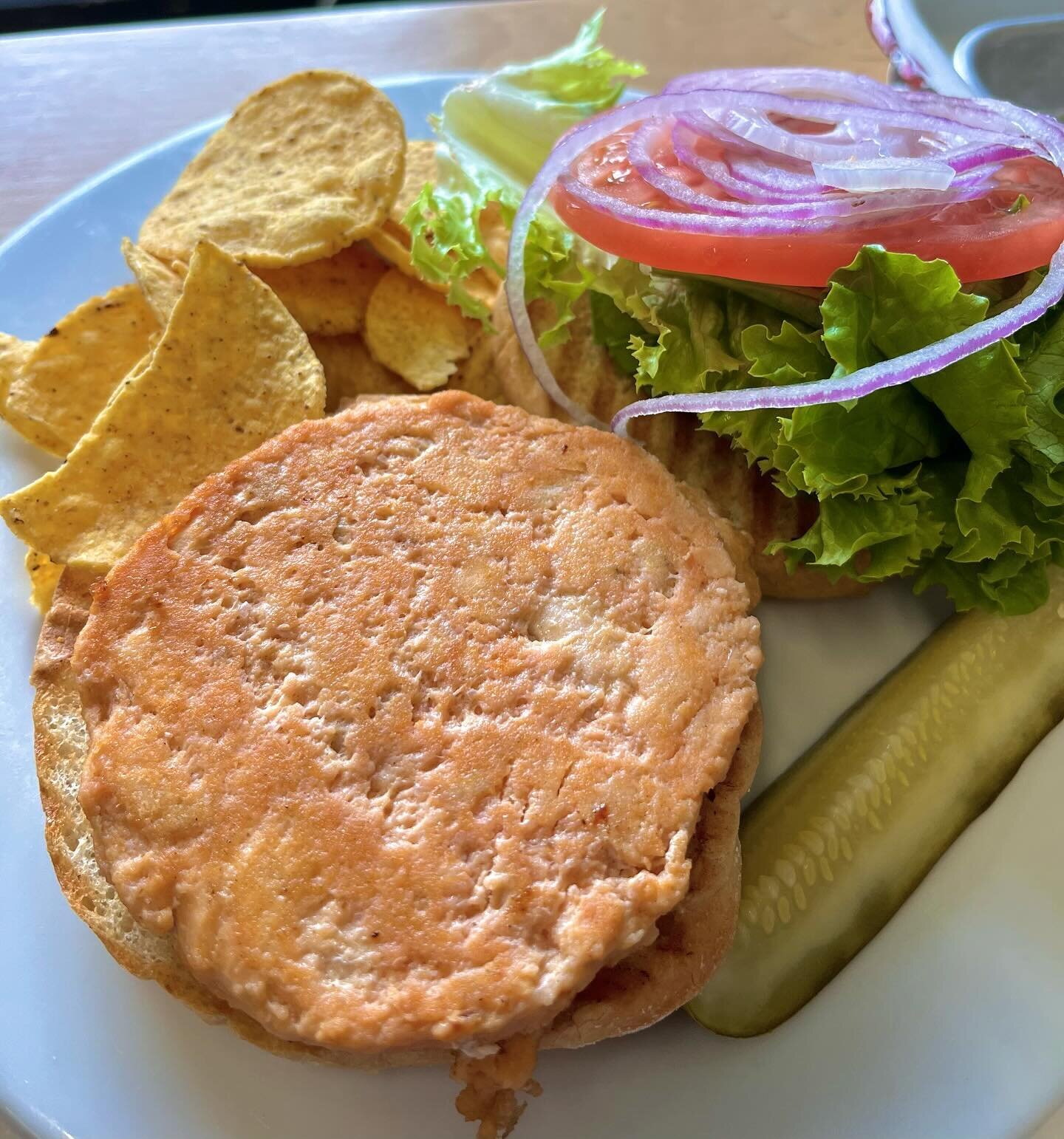 This THE LIFE 🎣 Wild caught Alaskan salmon  burger w/ lettuce, tomato, red onion &amp; lemon-dill mayo sauce on a roll

#amherst #cushmanmarketandcafe