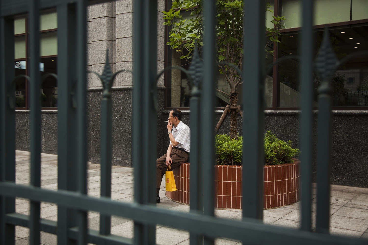 Man smoking a cigarette. Shanghai, China. 2012.