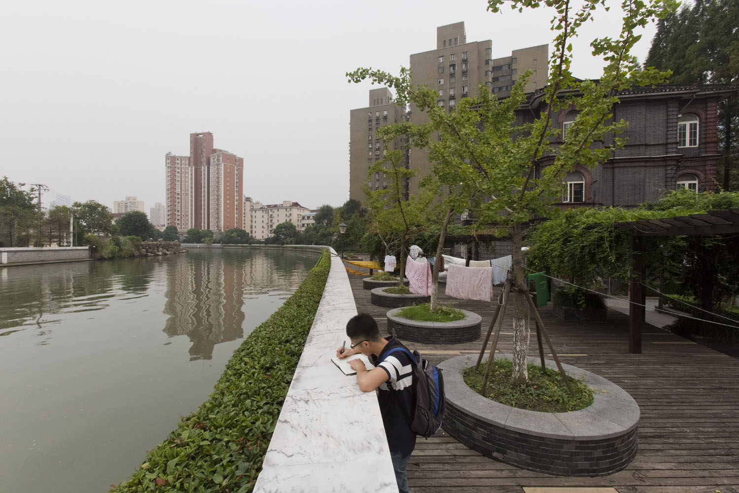 University student and Suzhou Creek. Shanghai, China. 2016.