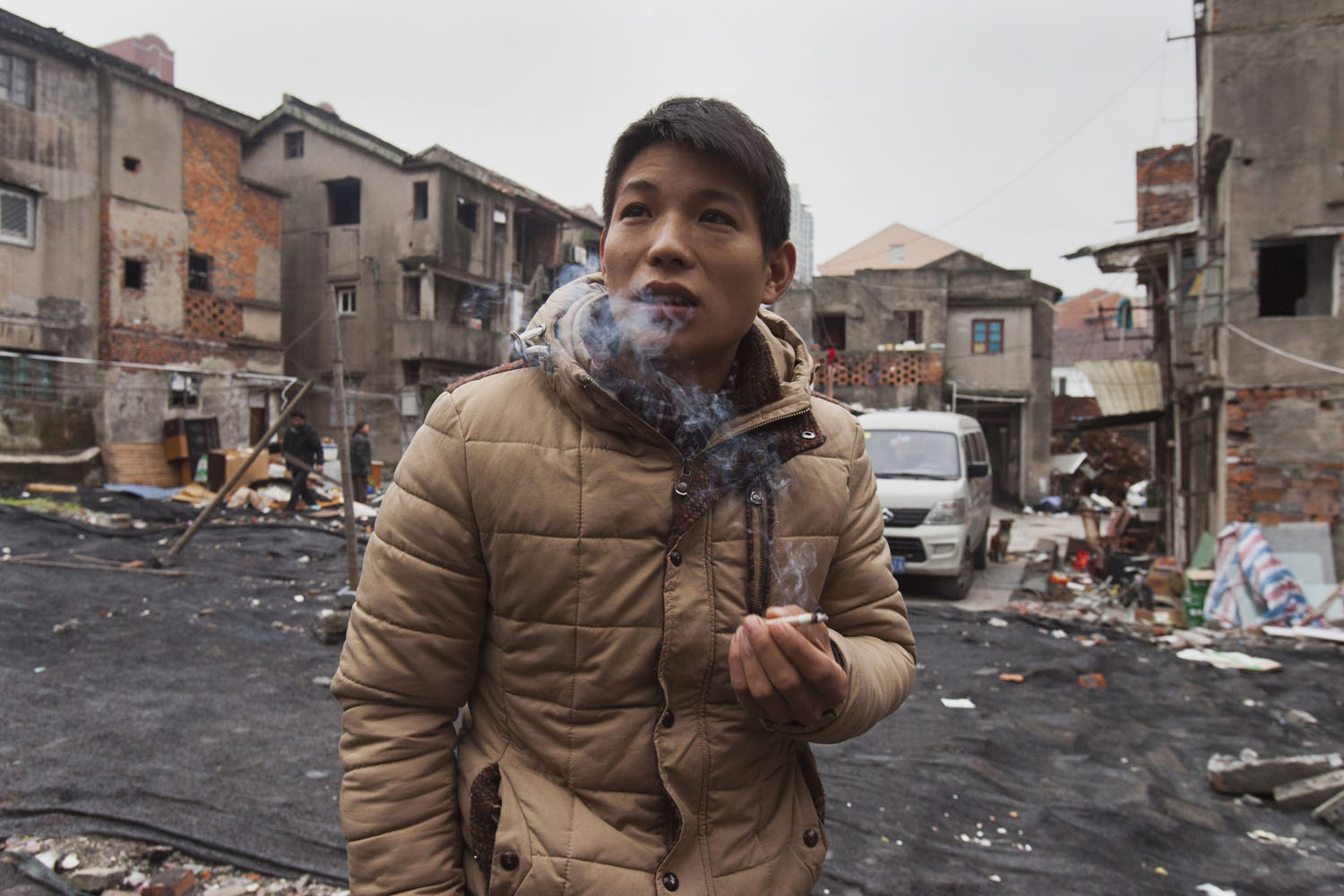 Migrant worker smokes and talks with residents. Guangfu Road. Shanghai, China. 2015.