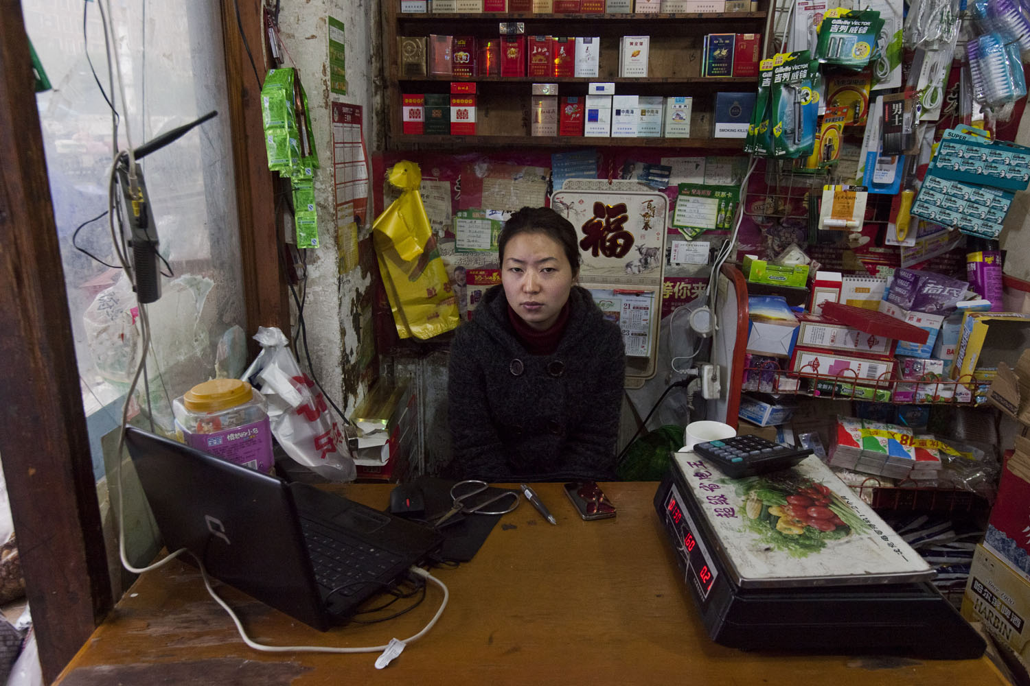 Shop keeper sits for a portrait. Guangfu Road. Shanghai, China. 2015.