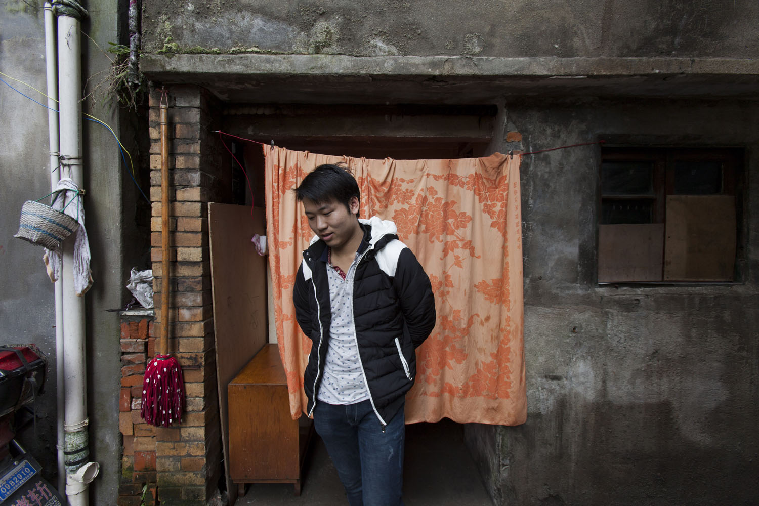 Young man waits for his portrait to be taken. Guangfu Road. Shanghai, China. 2015.