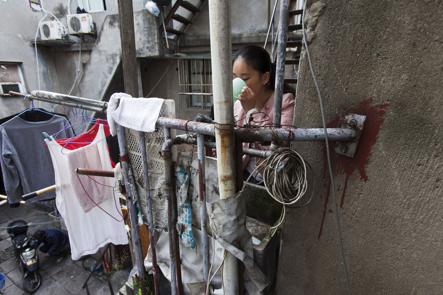 Young woman getting ready in the morning.. Guangfu Road. Shanghai, China. 2015.