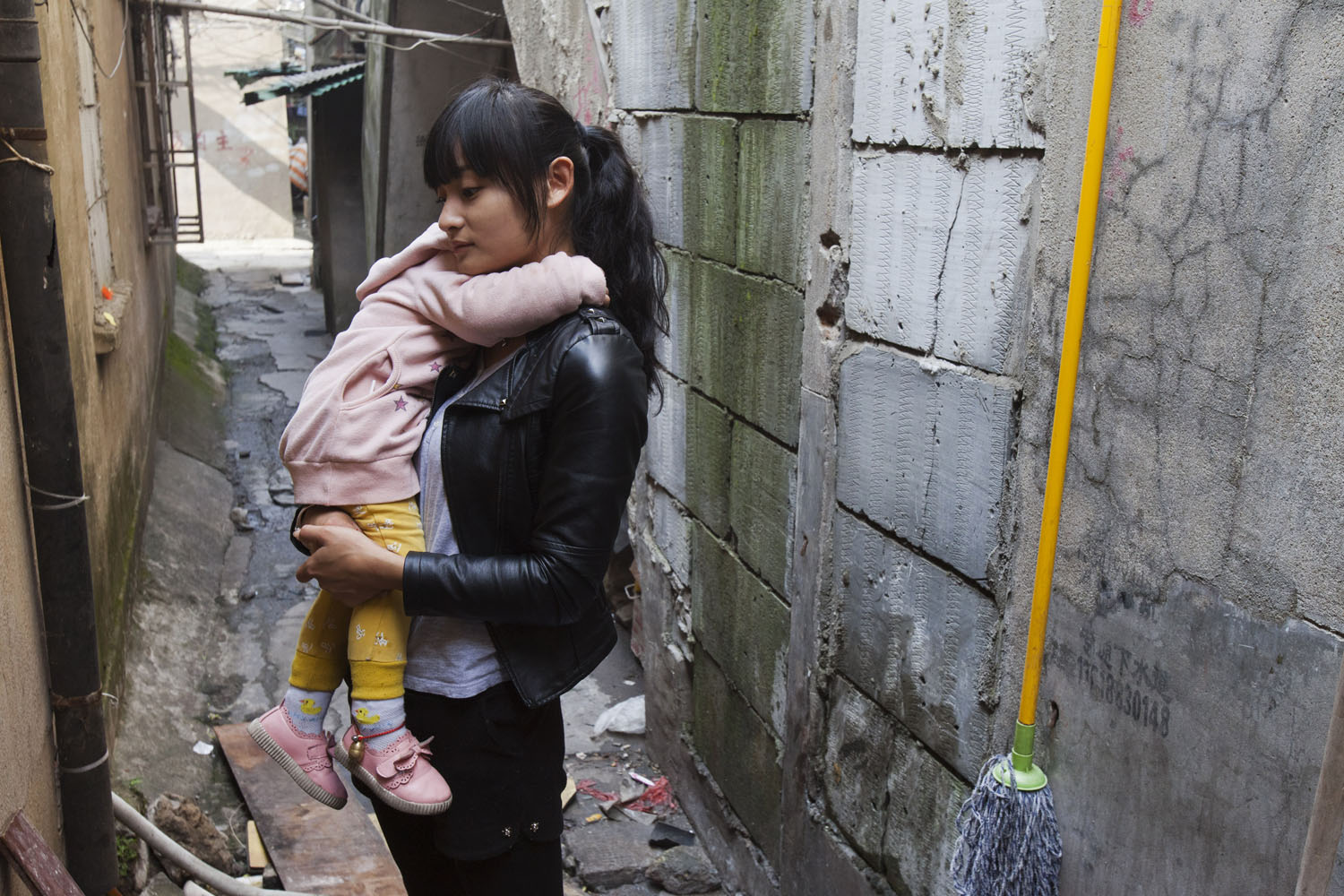   Woman and her child. Guangfu Road. Shanghai, China. 2015.