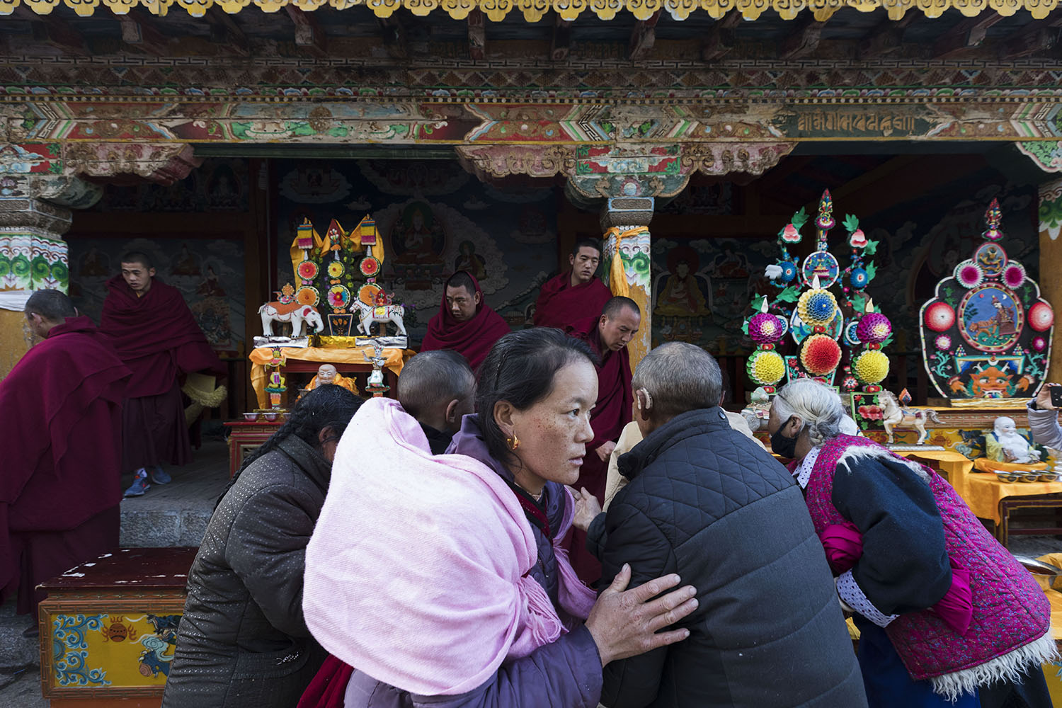 Devotees make offerings of prayer in return for holy water at SongZangLin Monastery in JingXiang Village. Yunnan, China. March 2, 2018.