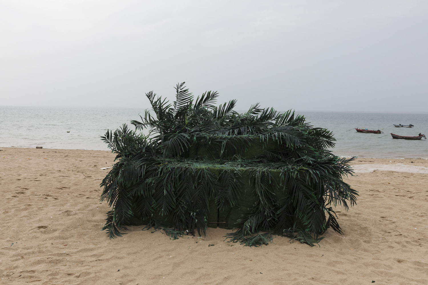 An altar decorated with imitation palm leaves, used for wedding photography at Guanyinshan Fantasy Beach. Xiamen, China. 2018.