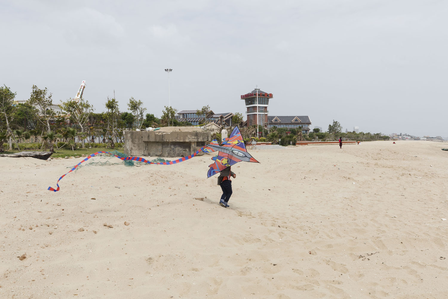 Boy with a kite at Guanyinshan Fantasy Beach. Xiamen, China. 2018.