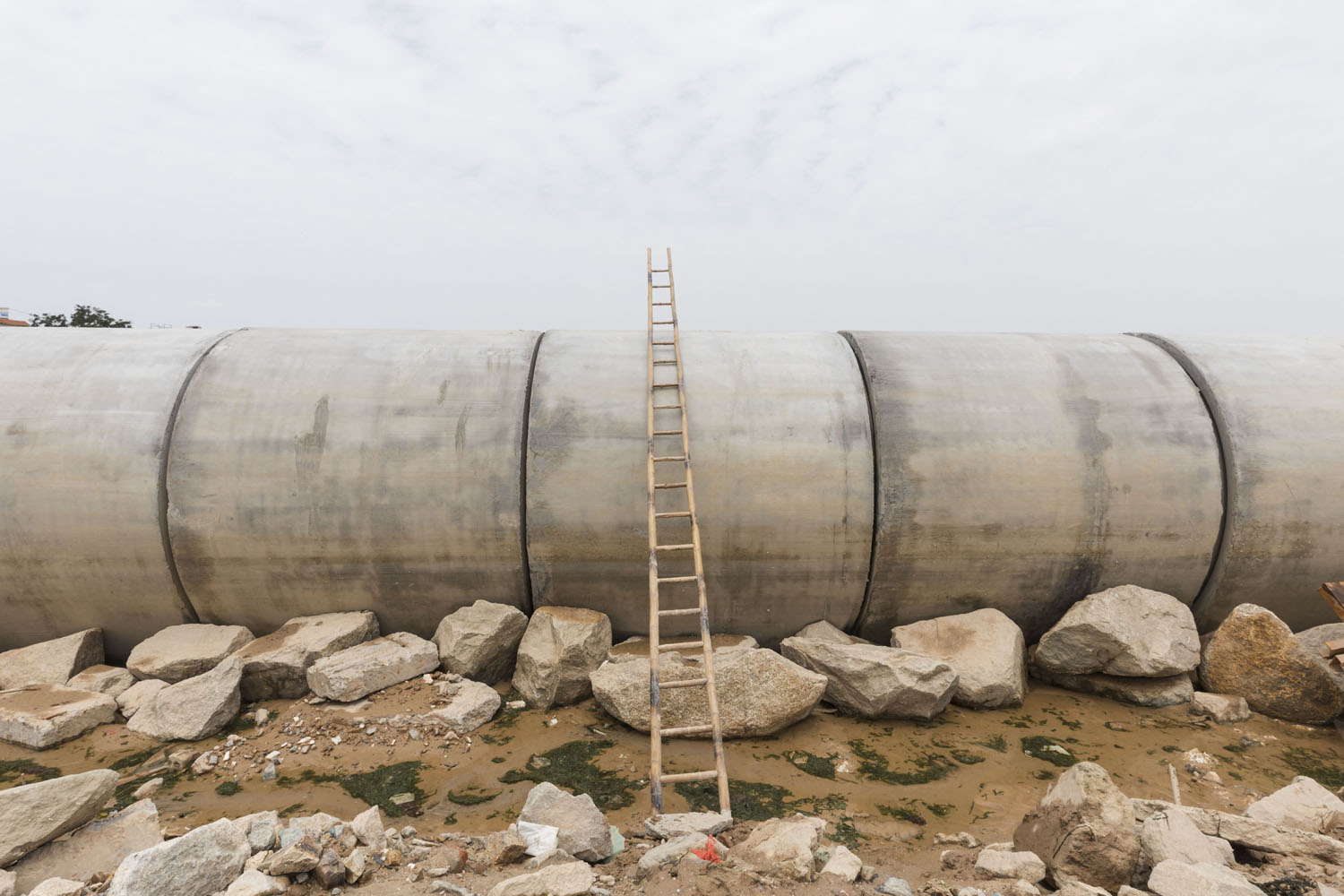 A ladder sits on an under construction pipeline at the north end of Guanyinshan Fantasy Beach. Xiamen, China. 2018.