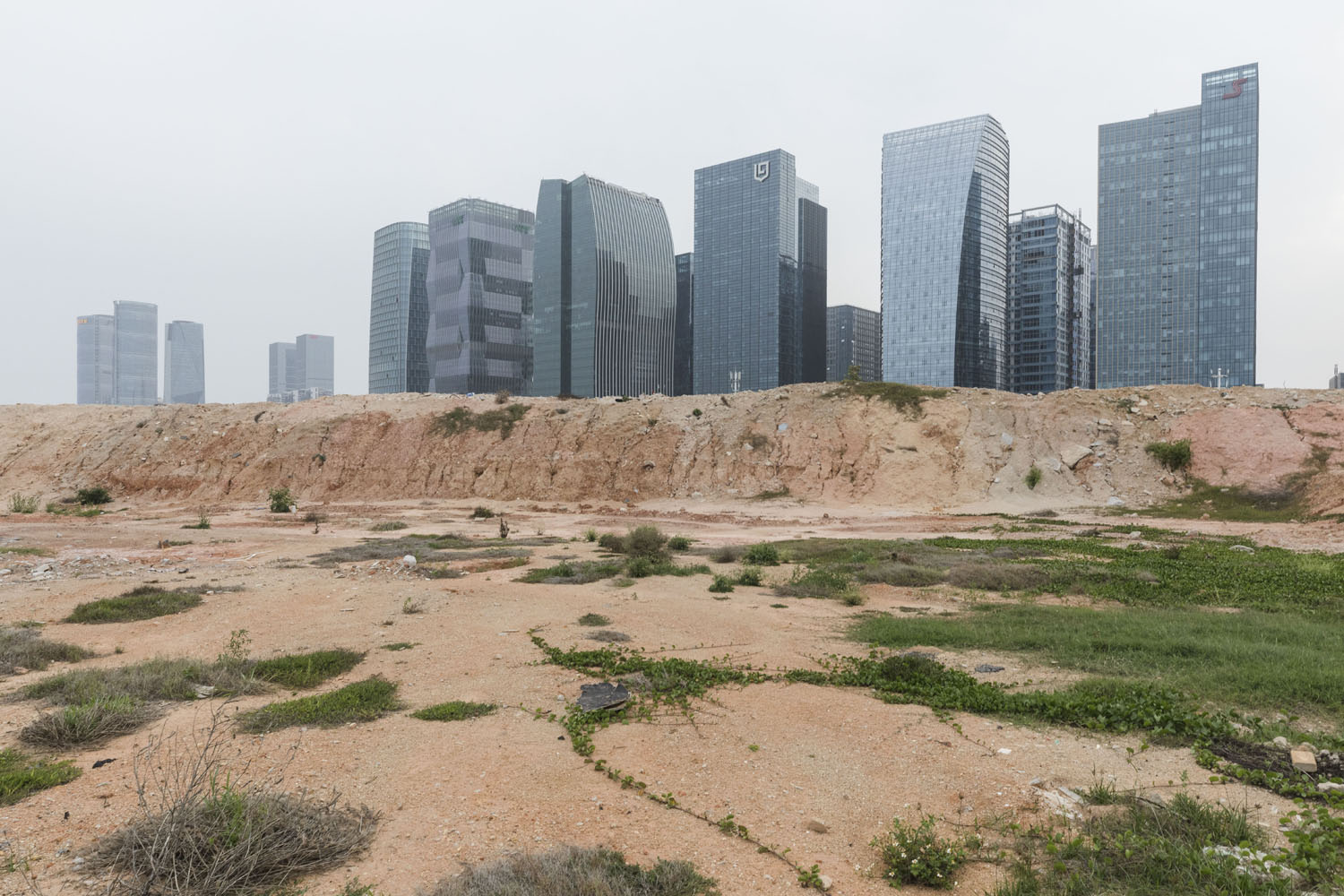 Undeveloped land that lies between a newly established business center and Guanyinshan Fantasy Beach. Xiamen, China. 2018.