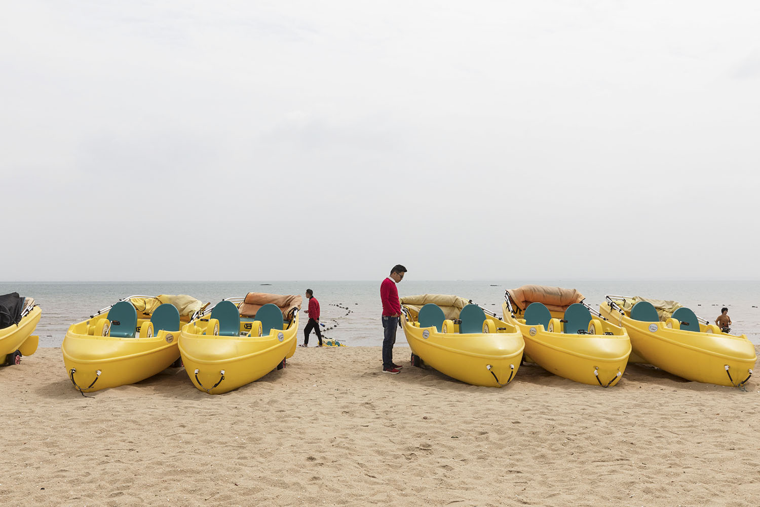 Small boats for tourists and beach goers at Guanyinshan Fantasy Beach. Xiamen, China. 2018.