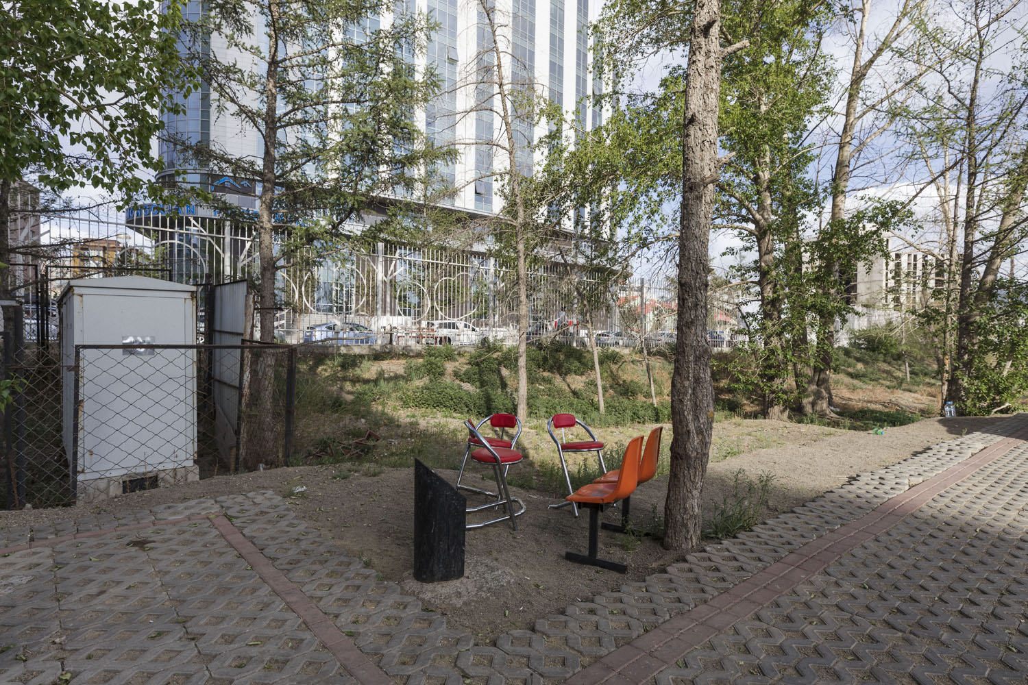 Several orange chairs at the entrance to an amusement park. Ulaanbaatar, Mongolia. 2018.