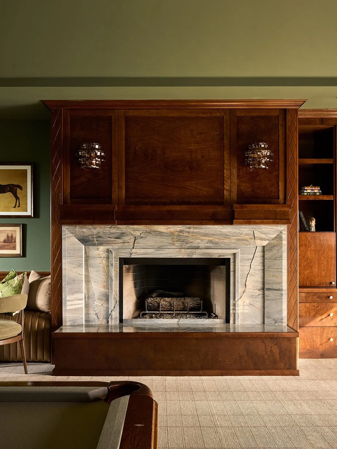 Subtle changes:
Paneled upper detail around hard wired sconces
Wood front hearth
Sculptured stone definition 
Saturated paint on walls and ceiling