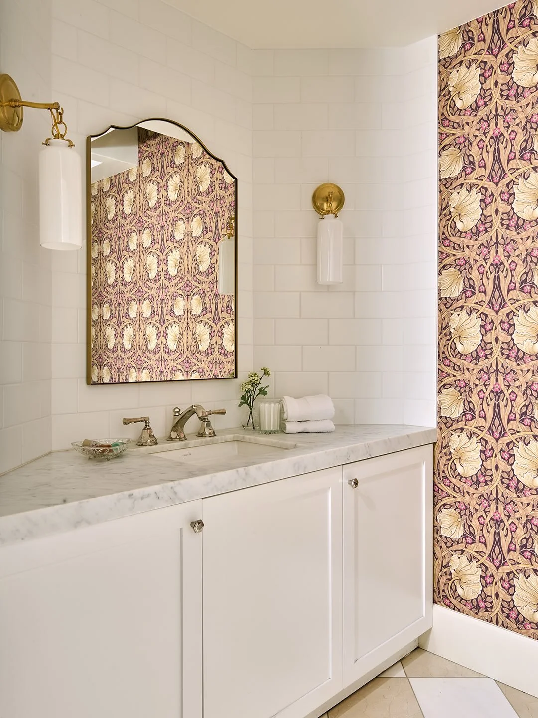 Ahhh, the infamous wallpaper bathroom. The before was great, graphic tile, chromes and silvers. AND, we wanted to warm it up with marble checkerboard floors, new mirror and sconces. Then we added wall covering in a deep plum and the space felt more c