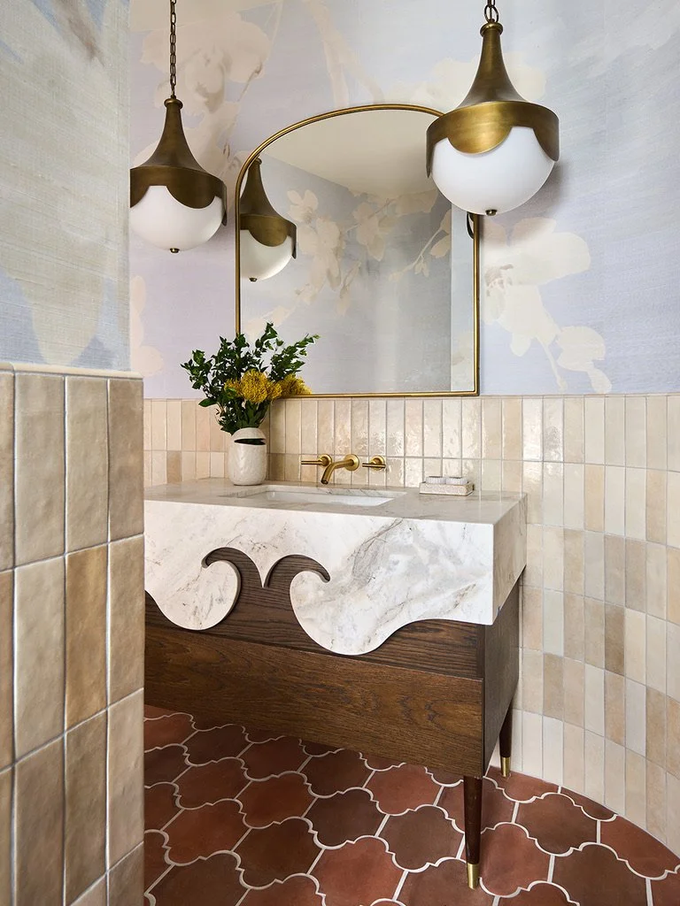 Custom bathroom remodel with floating vanity, decorative tile, and brass fixtures in a San Diego home by Savvy Interiors