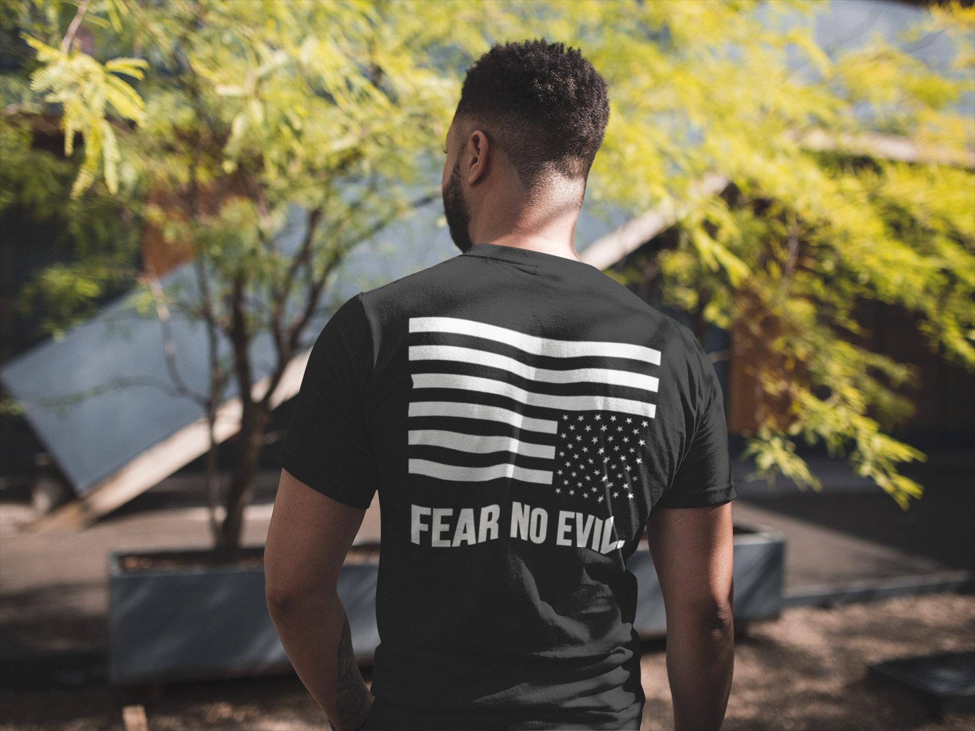 back-view-tshirt-mockup-of-a-man-facing-a-house-and-a-tree-21347 (1).png