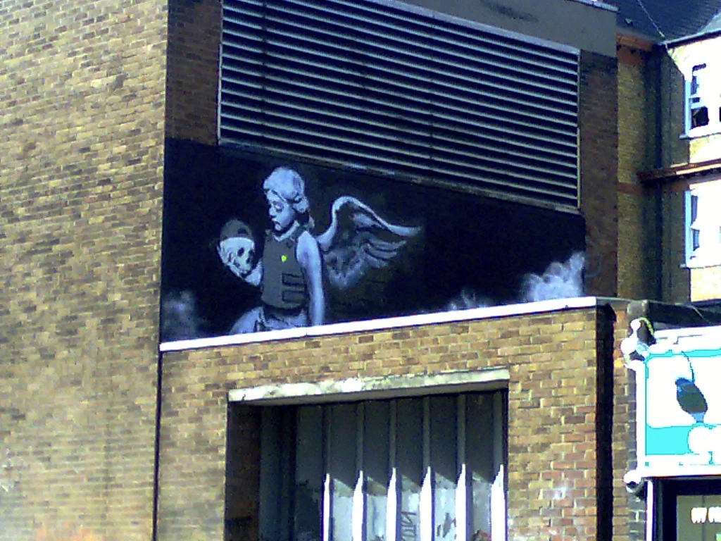 Ozone's Angel . Banksy @ Old St., photo by Darren from London, England - CC BY-SA 2.0