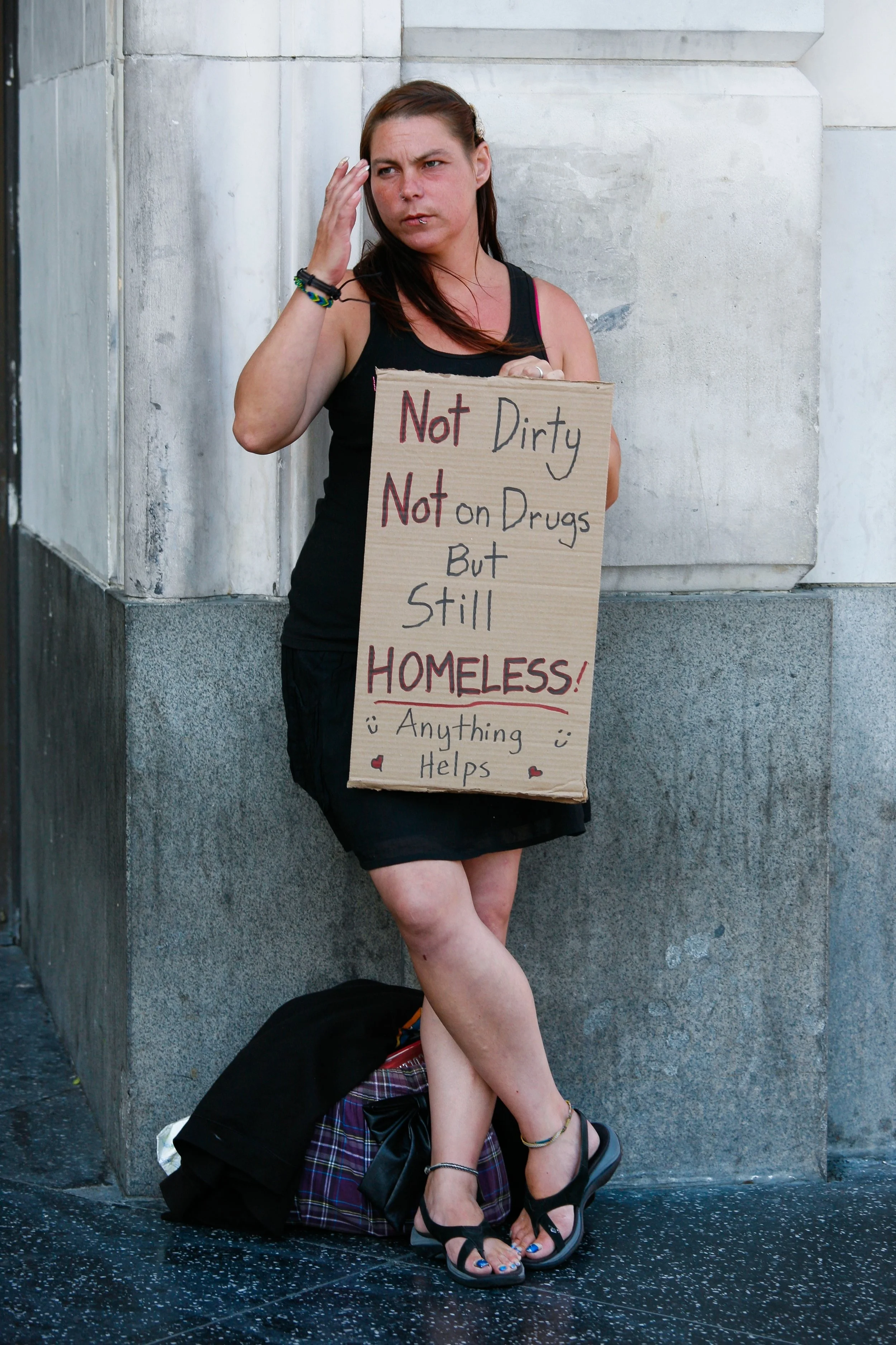 Homeless_female_holding_up_sign_(7617876912).jpg