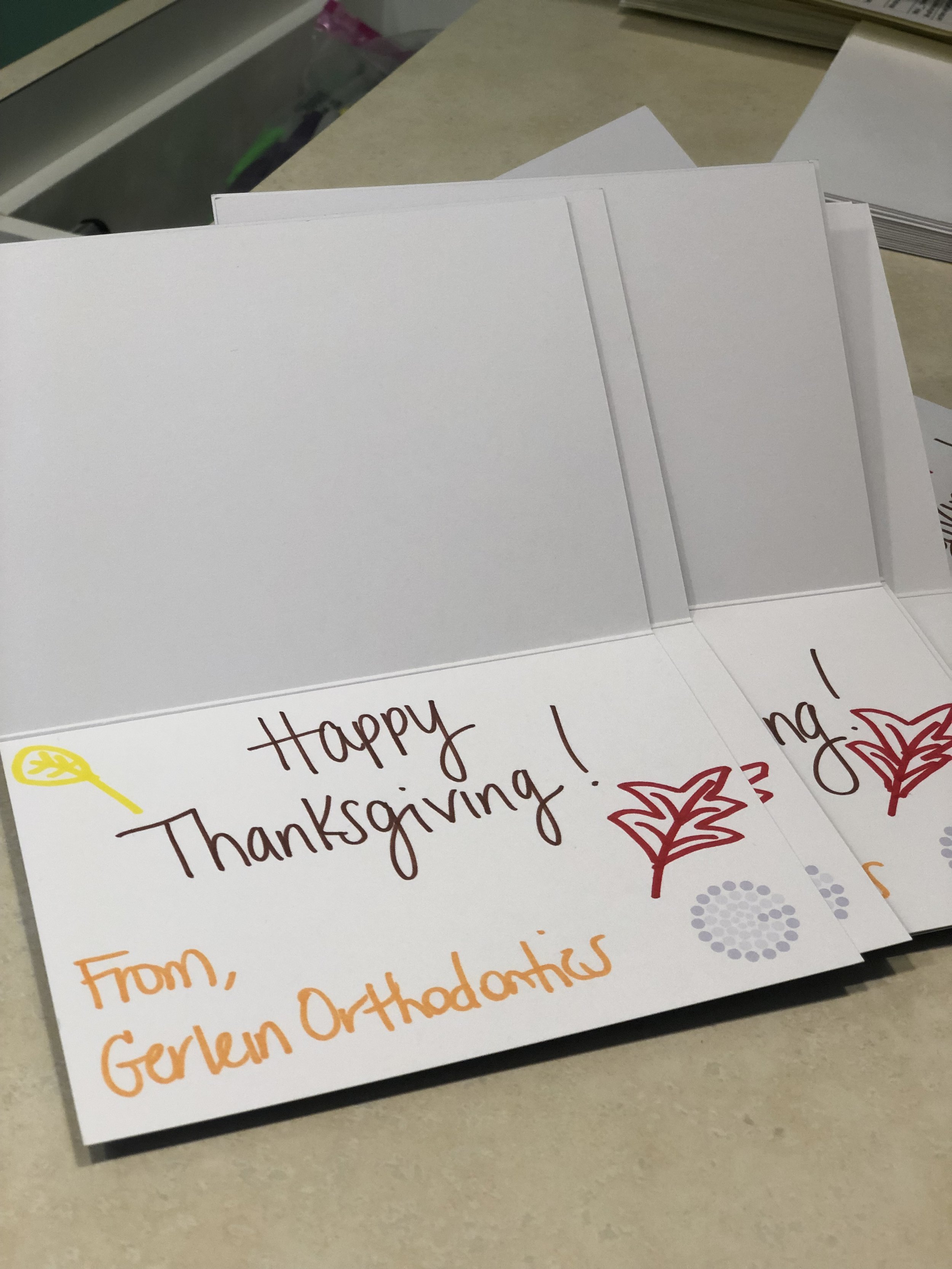 Cards included in donated thanksgiving food items. Card reads Happy Thanksgiving from Gerlein Orthodontics!