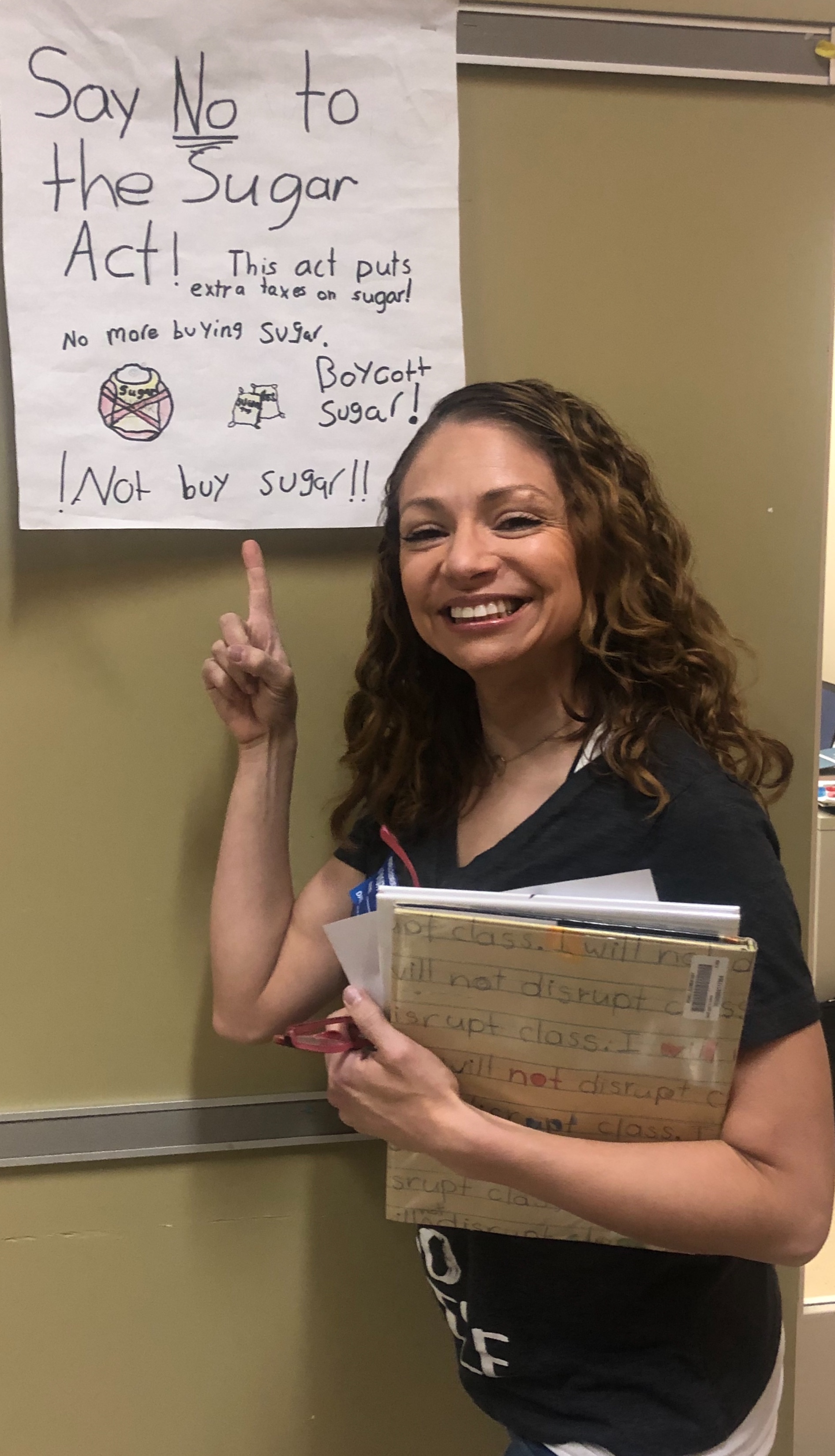 Gerlein team member smiling while pointing at poster. 