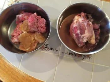 The bowl on the left gives a good example of the consistency of well made bone broth. It's the gelatin like substance on top of the food.