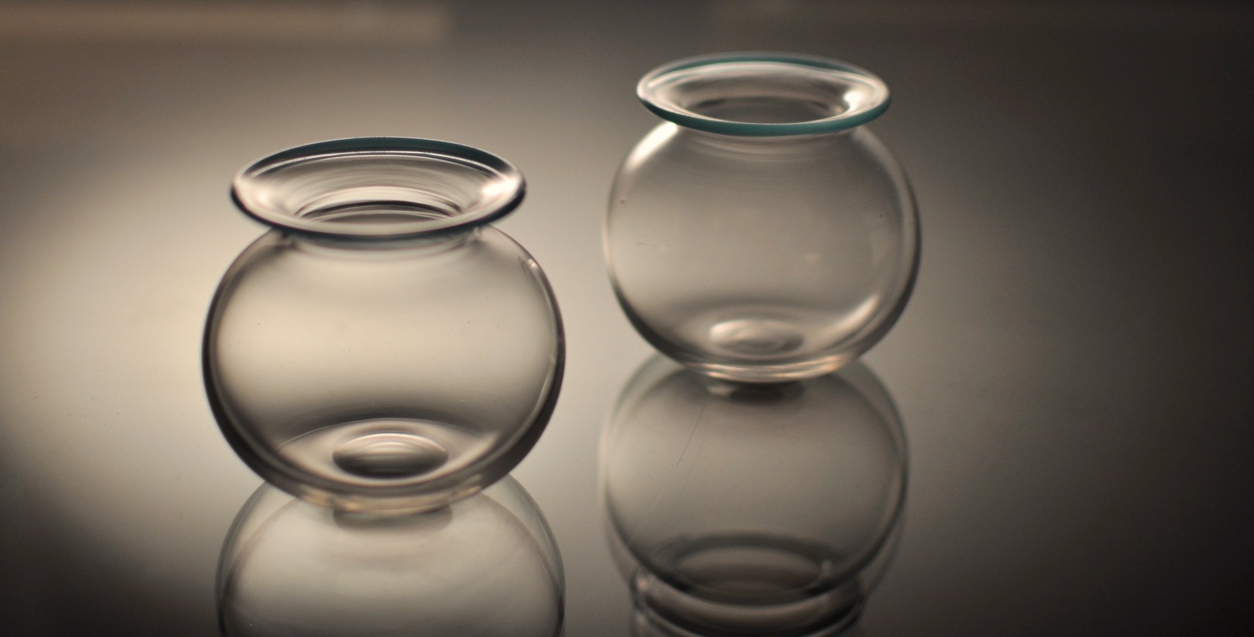 Pair of small globular vases in clear glass with applied blue lip. British, Late 19th C