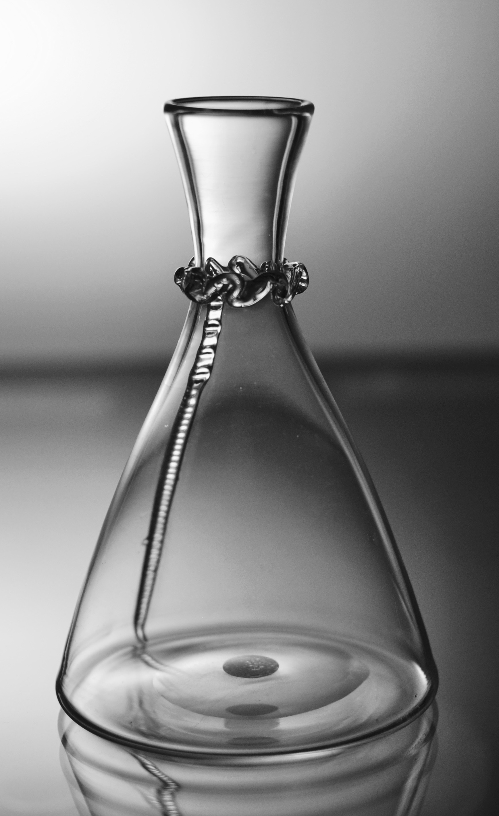 Small carafe in fine quality pale grey glass: “leather bottle” design. Probably Whitefriars, English C1870. It is in good condition and, unusually, only 14cm tall. The item is currently on display at Fortnum & Mason, Piccadilly.