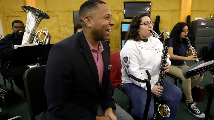 Tony Brown, the executive director of the nonprofit Heart of Los Angeles program, visits young orchestra students on the HOLA campus in Los Angeles. (Glenn Koenig / Los Angeles Times)