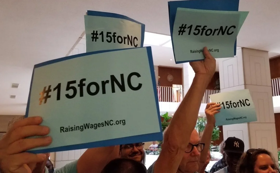outside press conference blue signs.jpg