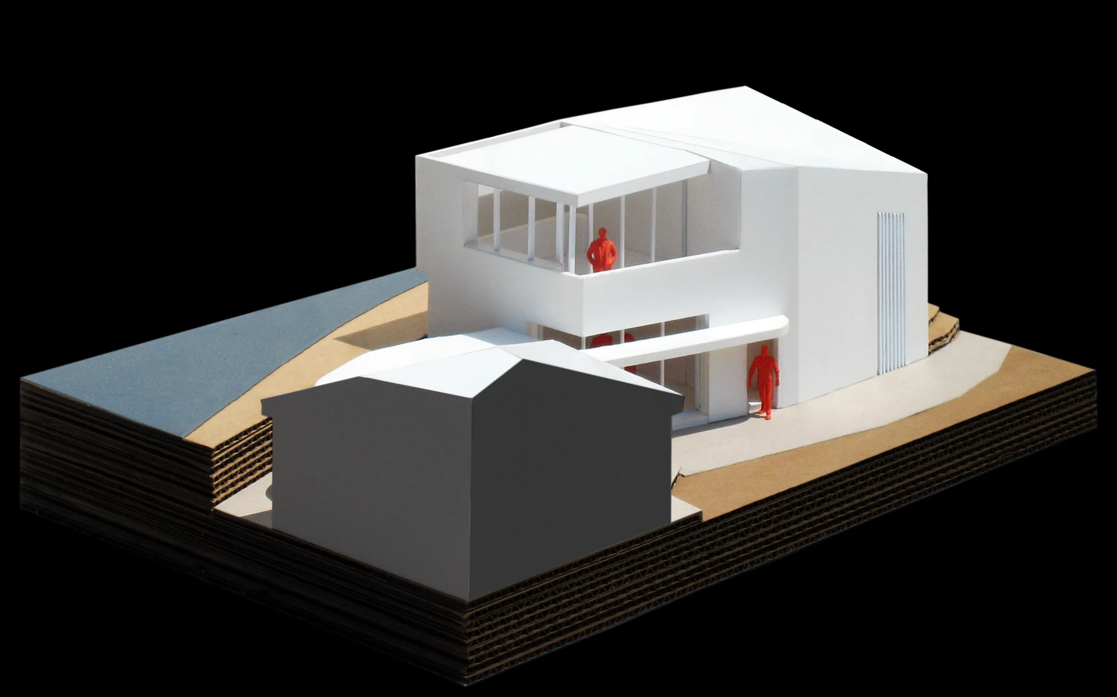 A model of the studio with a portion of the existing house in the foreground.