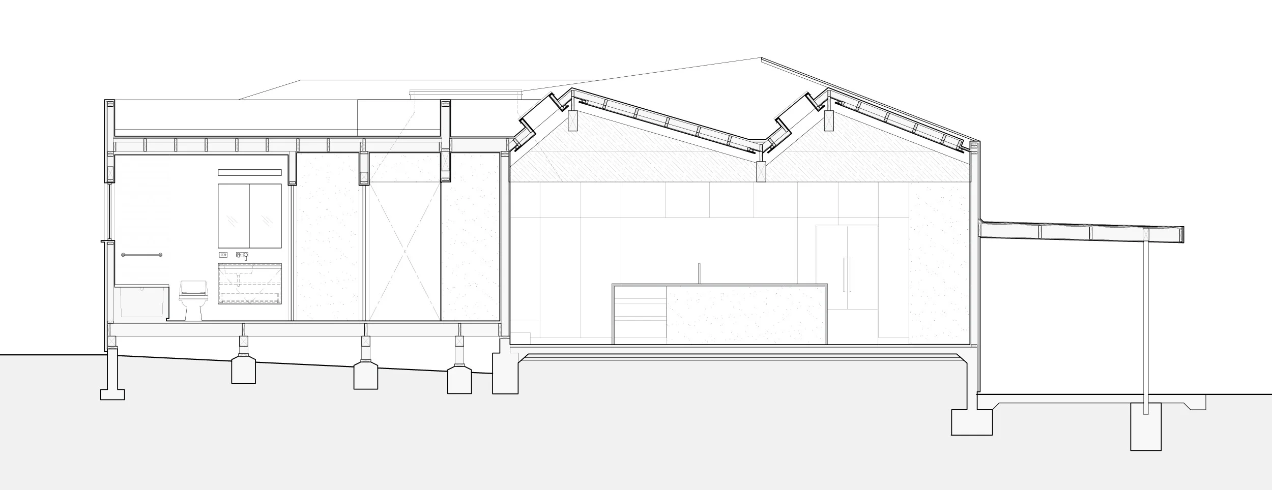 Section though the living room showing the sawtooth roof and kitchen beyond.