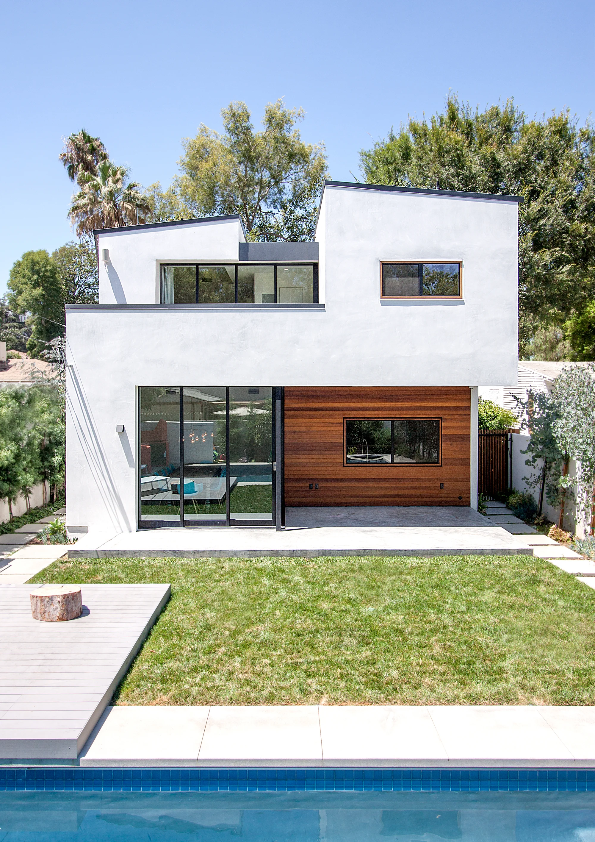 The doors at the rear of the house slide to create a seamless connection between the living spaces and the backyard. On the second floor, the doors open from the master suite to a large balcony that overlooks the pool.