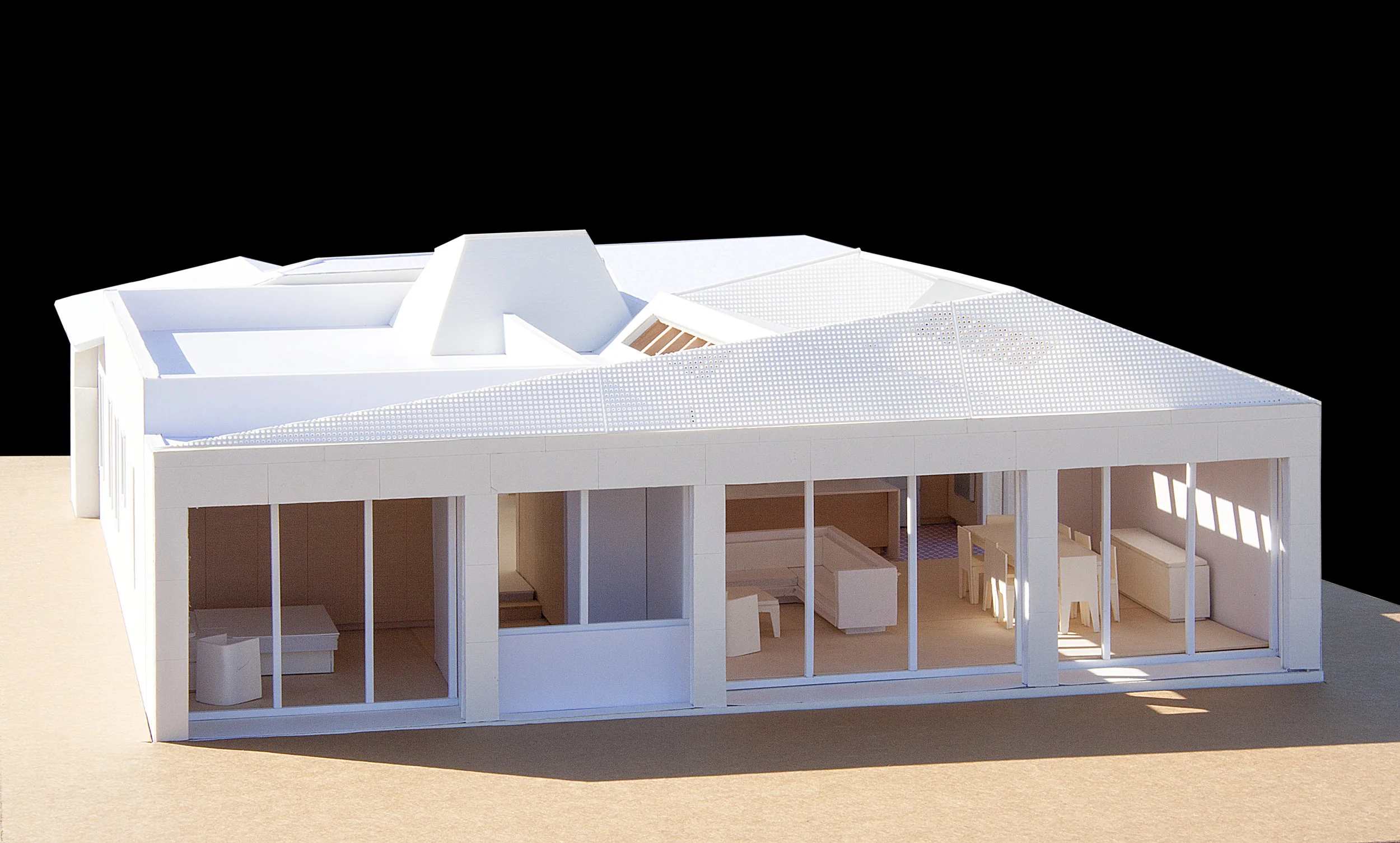 The transparent screen is made out of a perforated metal that unifies the saw tooth roofline with the rear facade.
