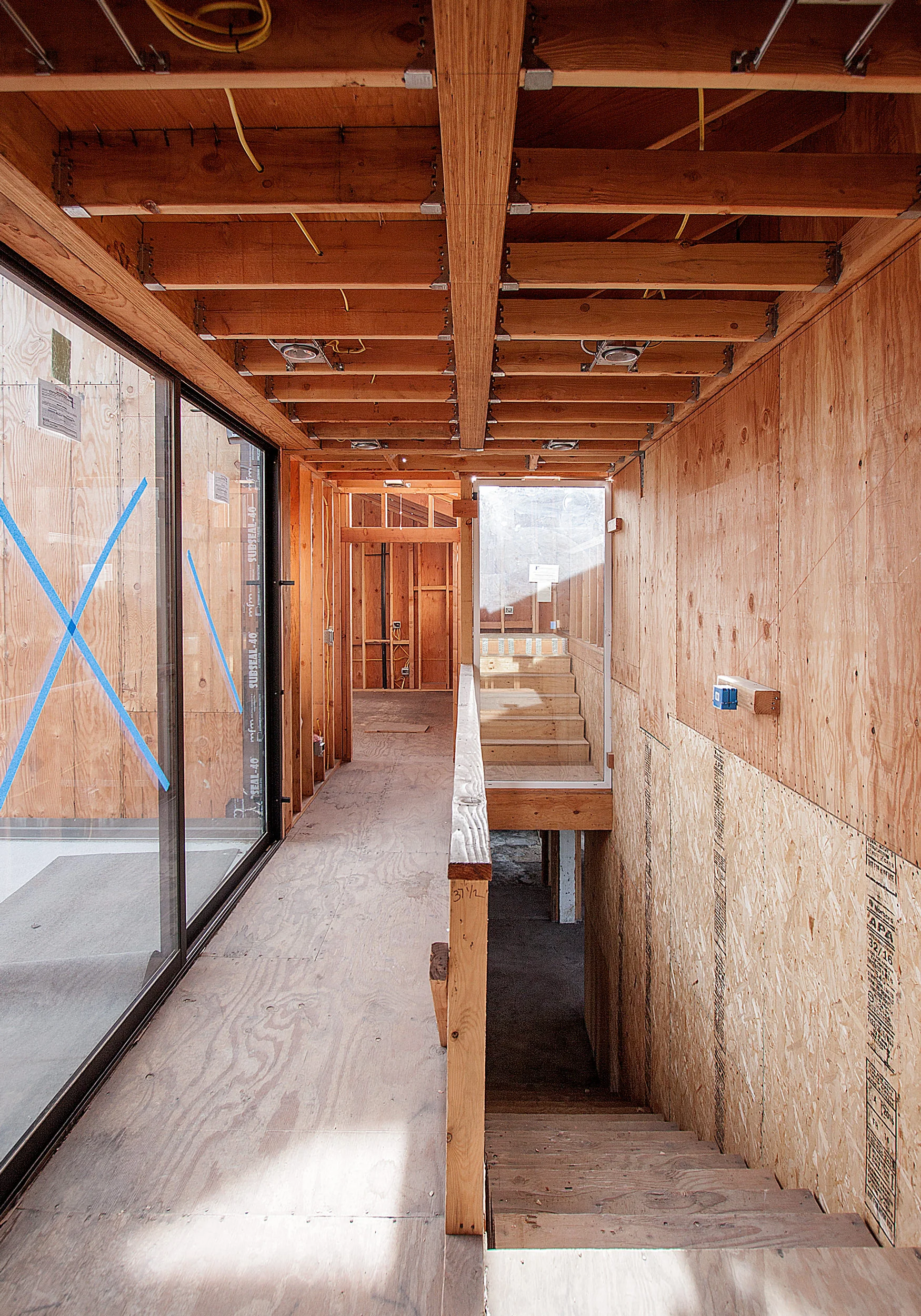 View of the of the hall to the bedroom sweets with slidign doors that open to a terrace.