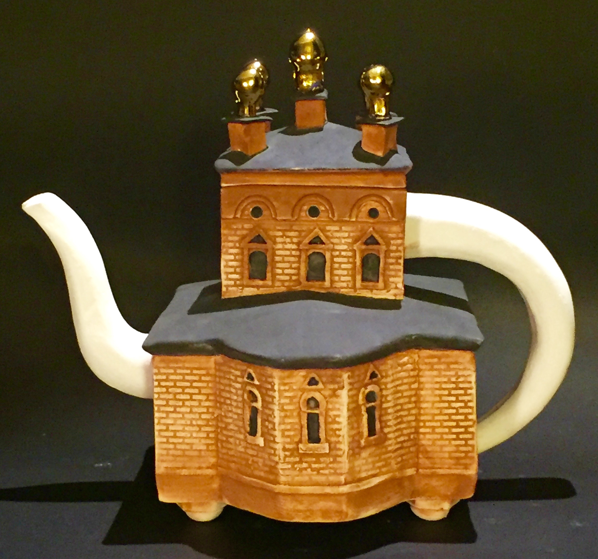 ST. PANTELEIMON RUSSIAN ORTHODOX CHURCH TEAPOT , Hartford, CT Slip cast and handbuilt, underglaze, glaze and 18 K yellow gold overglaze. 6" x 5" x 4", $125.00