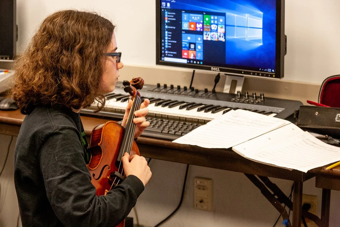 Plucking out a melody in Composition class. Courtesy of Sitka Fine Arts Camp.