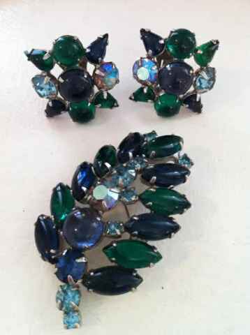 I have owned this beautiful jeweled Weiss blue and green leaf pin and matching earrings since the late 1950s. I wore them with a soft blue wool dress that I made.