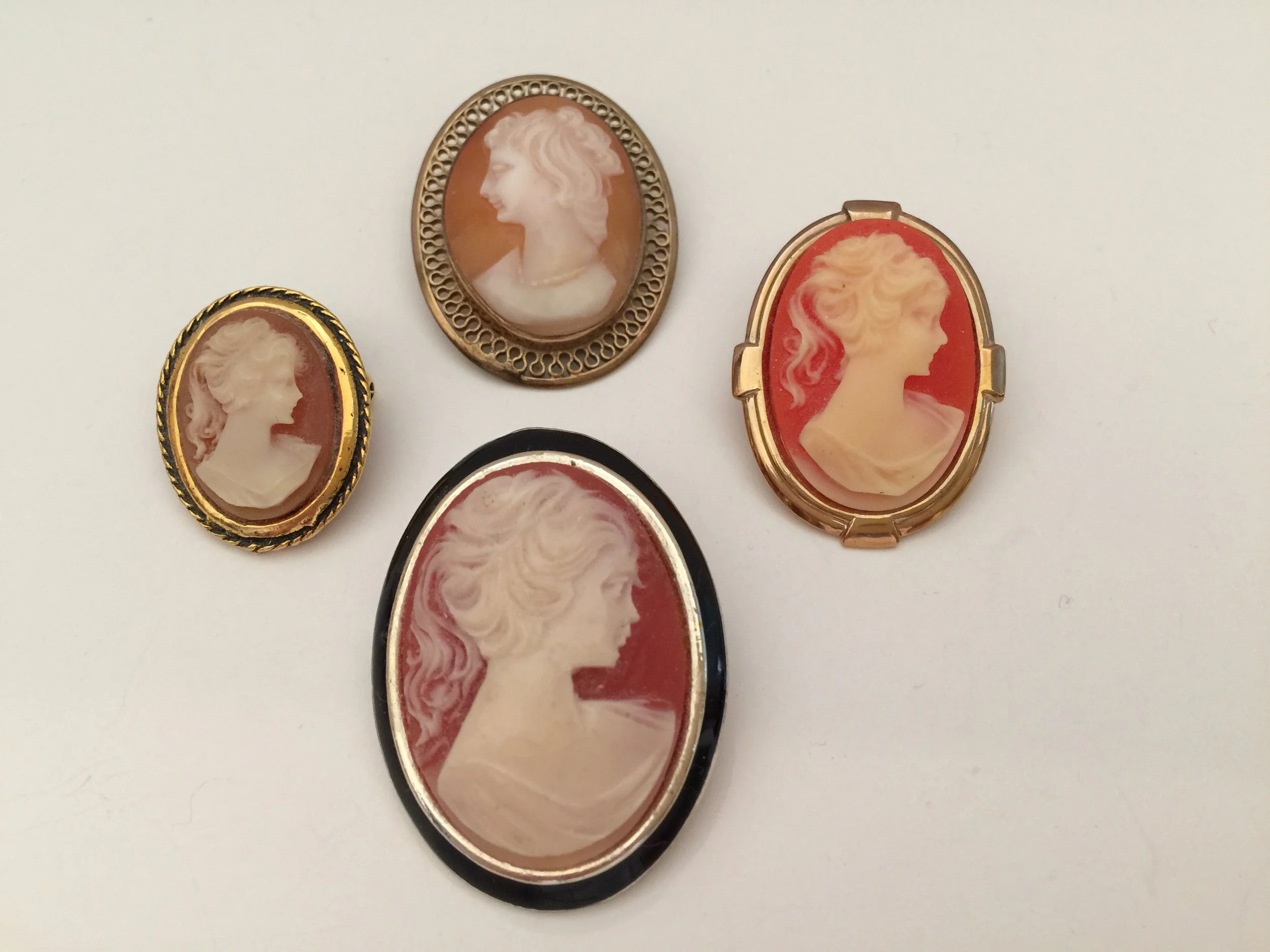 I have always loved cameos. The pin at the top is the oldest; it is a Winard brand pin that is 12 K gold filled.