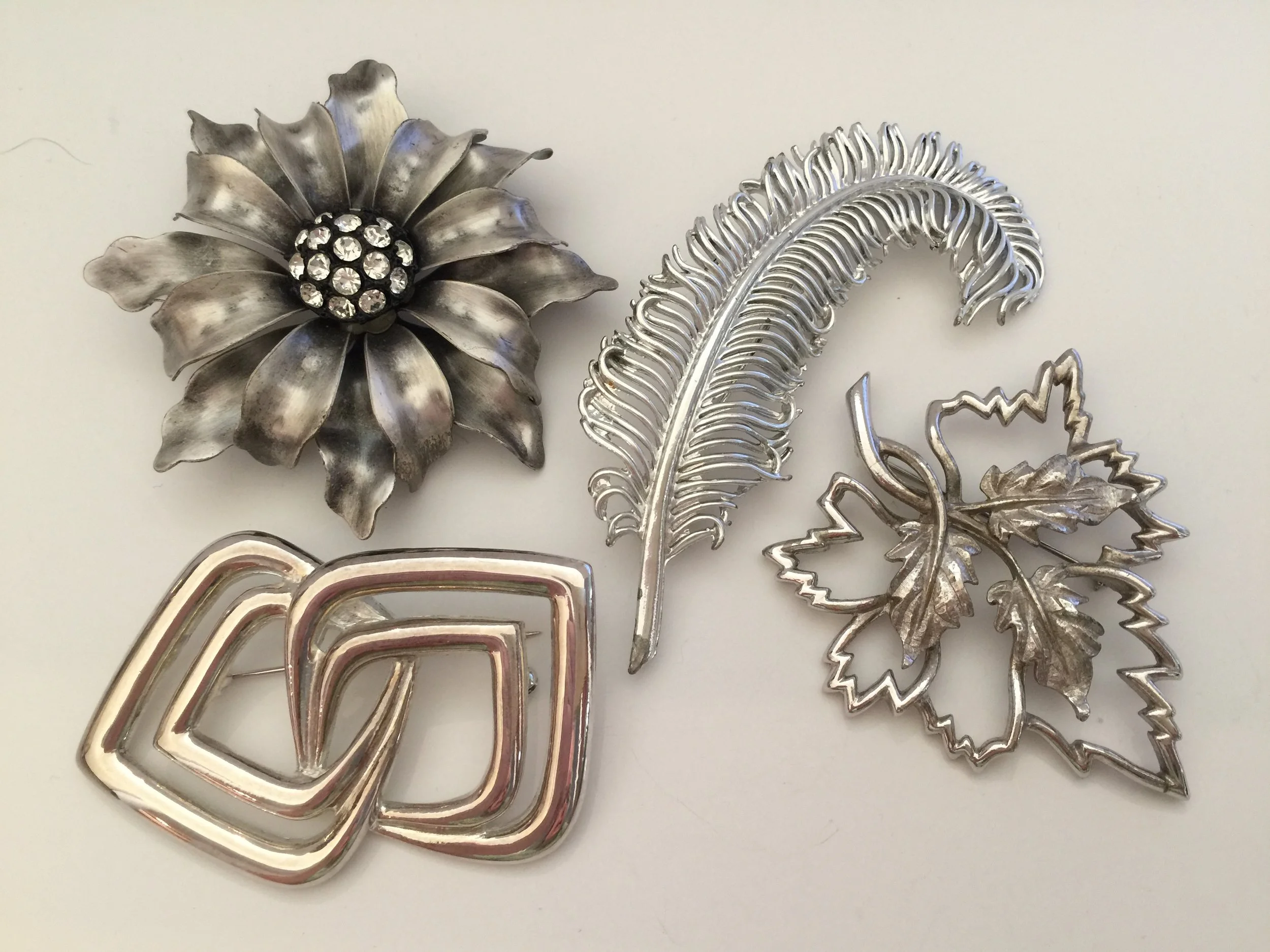 Silver pins ... the feather is a Coro pin and the leaf is an Emmons about 1960