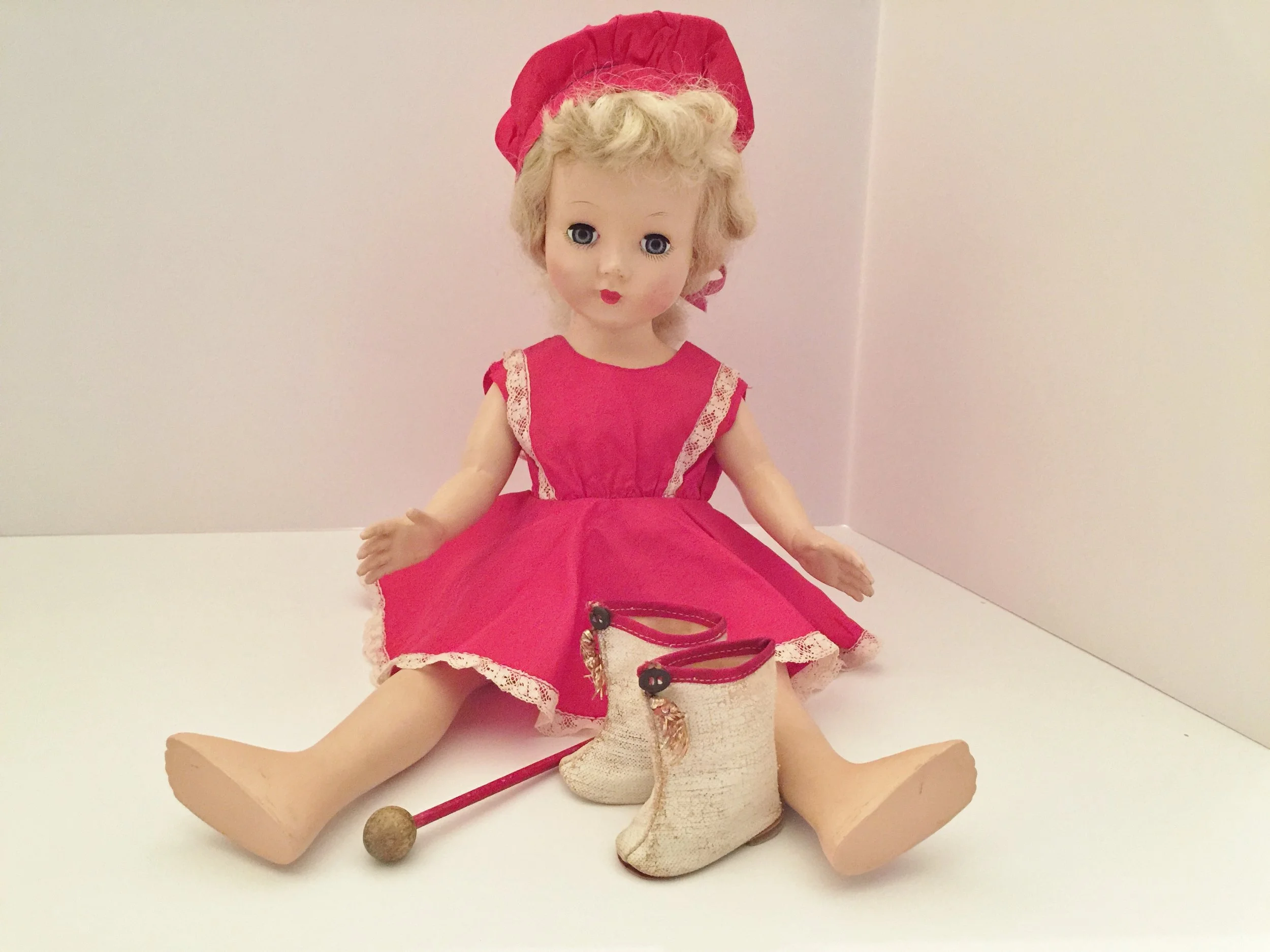 Honey is wearing the majorette costume that my mother made. Majorette and ice skating dolls were very popular. I still also have the boots and baton. Having the boots helped me find out what size replacement shoes to purchase.