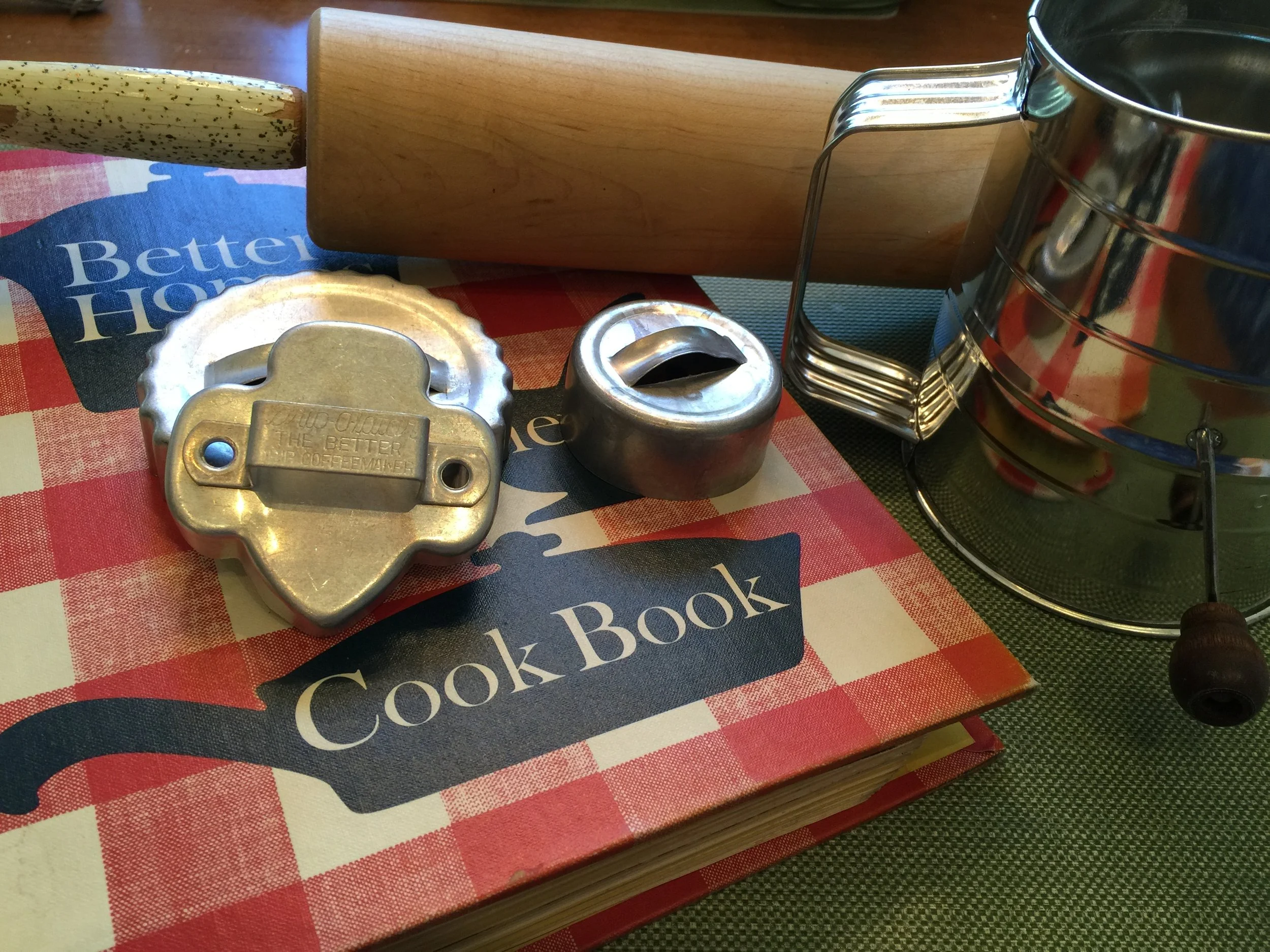 My own cookie making equipment ... 1964 edition of the famous red and white checked Better Homes and Gardens cookbook, sifter, rolling pin and cookie and biscuit cutters. These have been mine for more than fifty years ... hard to think of my own things being VINTAGE!