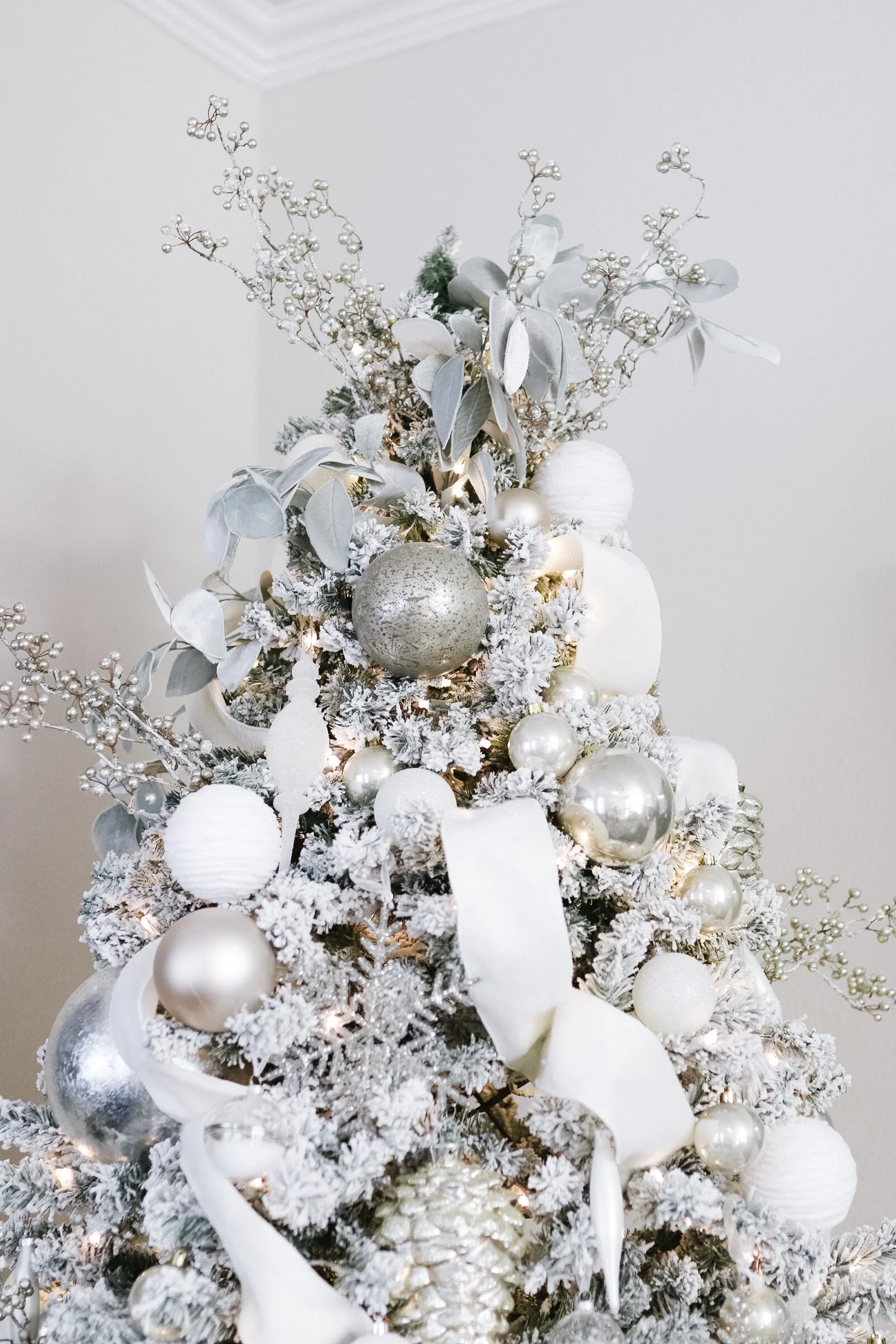 Flocked white Christmas tree with all white and silver decorations