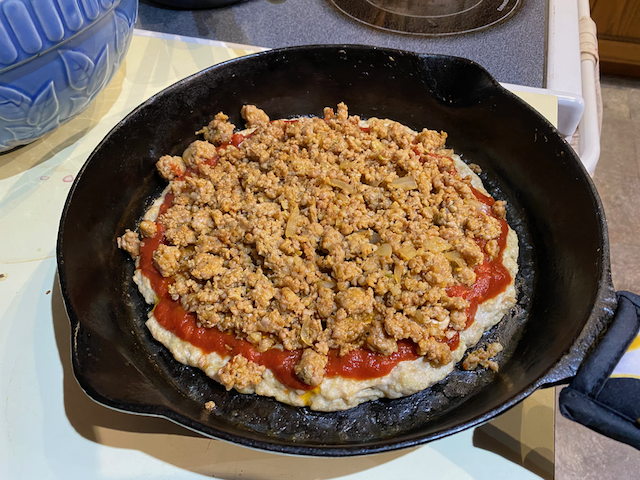Adding the cooked hot Italian sausage.