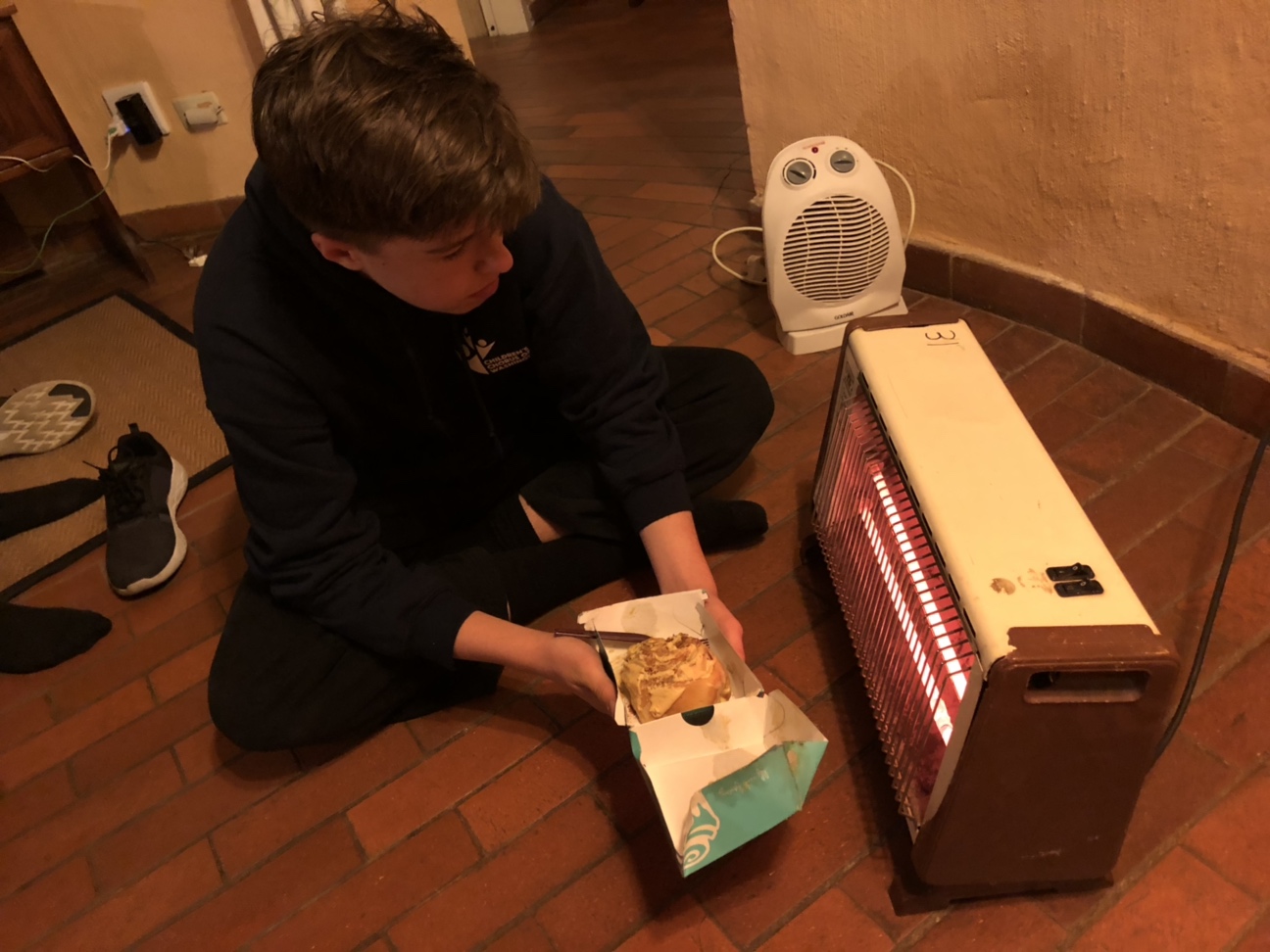 Jack heating his Cinnabon by the space heater. Photo: Sam Mencimer