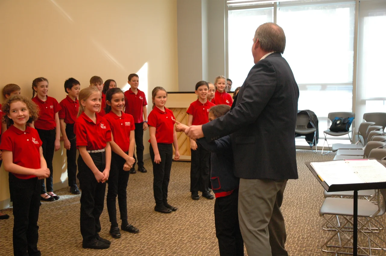 Mr. Cotton asks one chorister to conduct