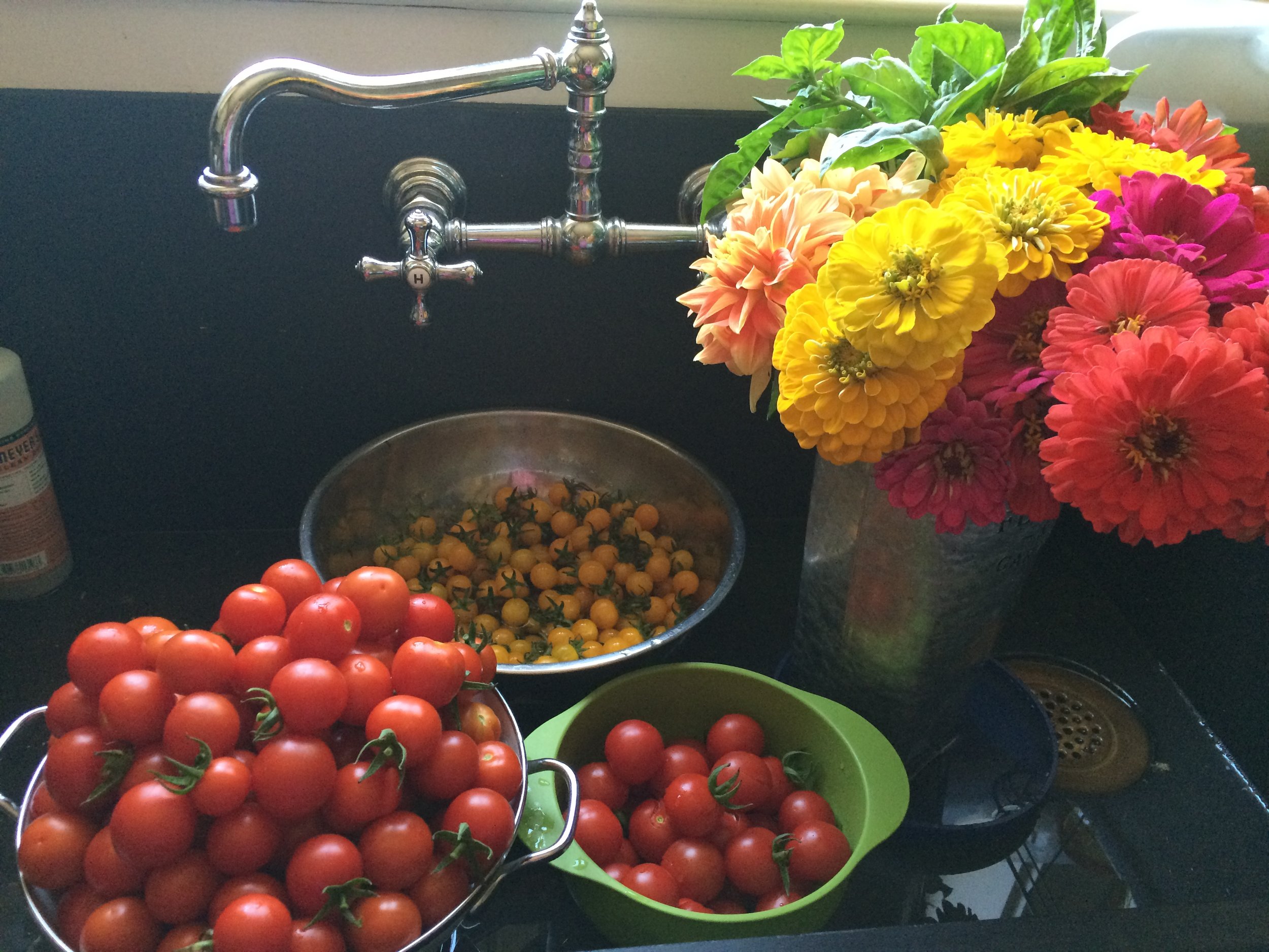 Fresh flowers and tomatoes in sink