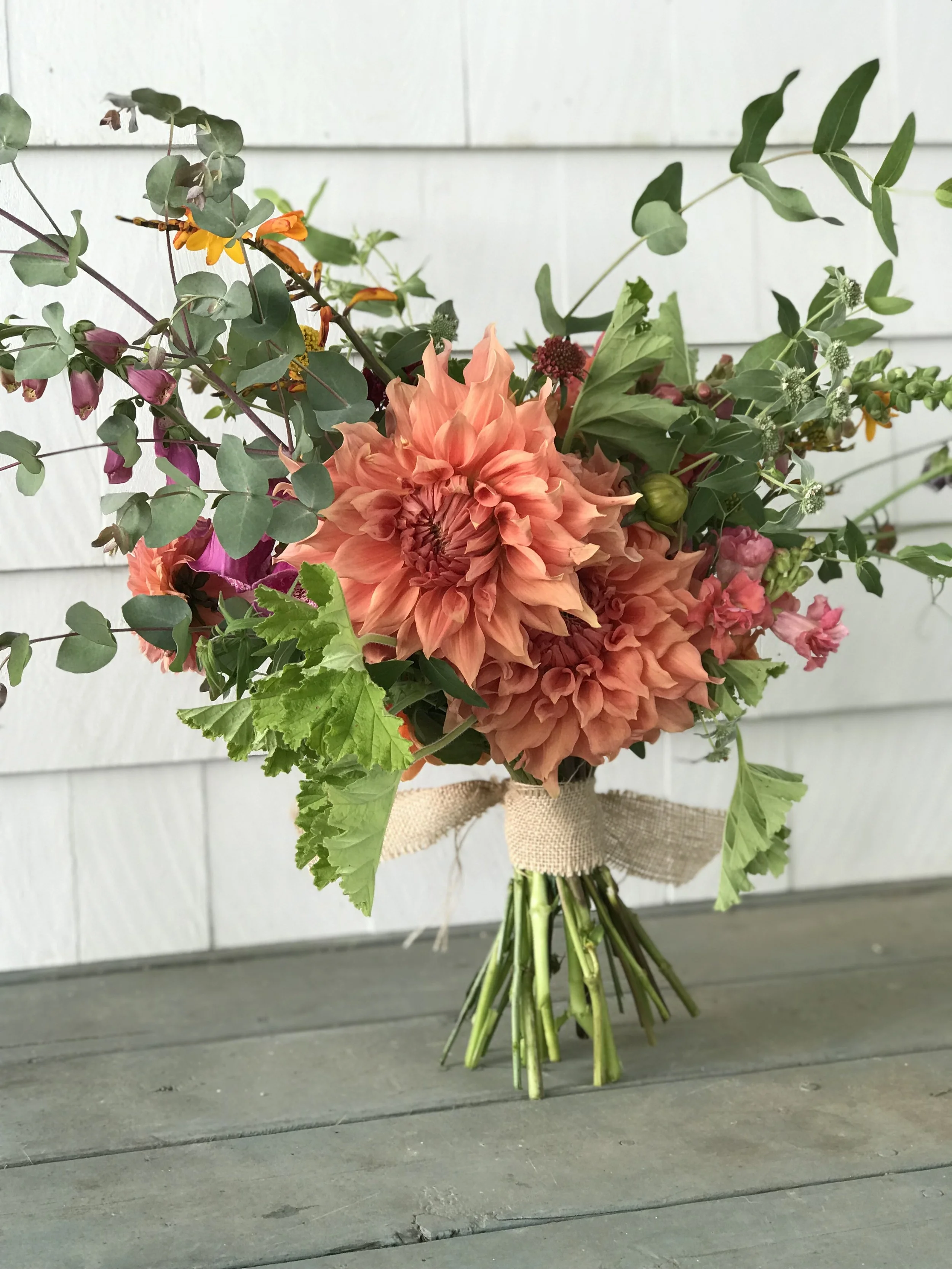 sierra glow dahlias in handheld bouquet
